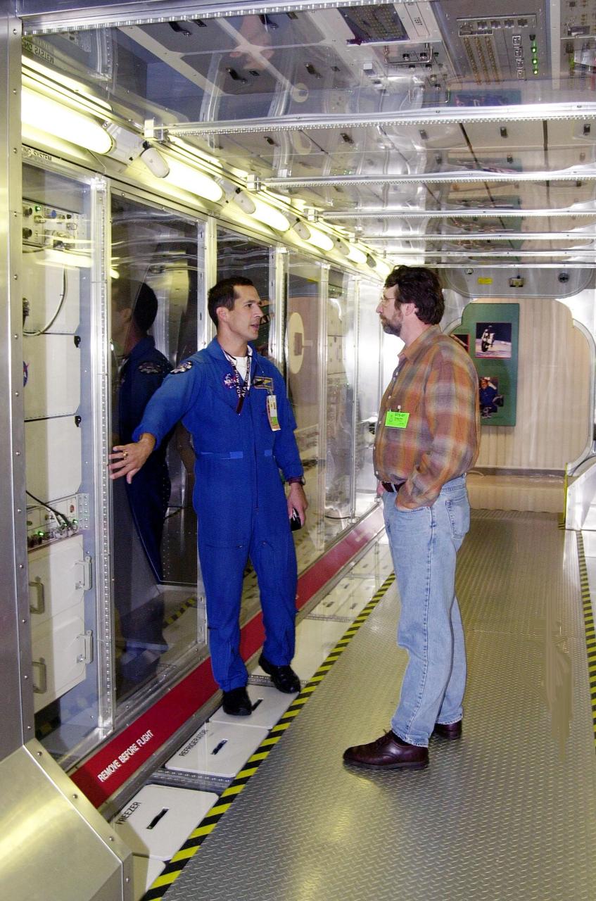 KENNEDY SPACE CENTER, FLA. -- Astronaut John Herrington (left) shows a mockup of the U.S. Lab to Norm Abram, master carpenter of television’s  "This Old House" and "The New Yankee Workshop." Abram is at KSC to film an episode of "This Old House." The mockup lab is in the International Space Station Center, a tour facility