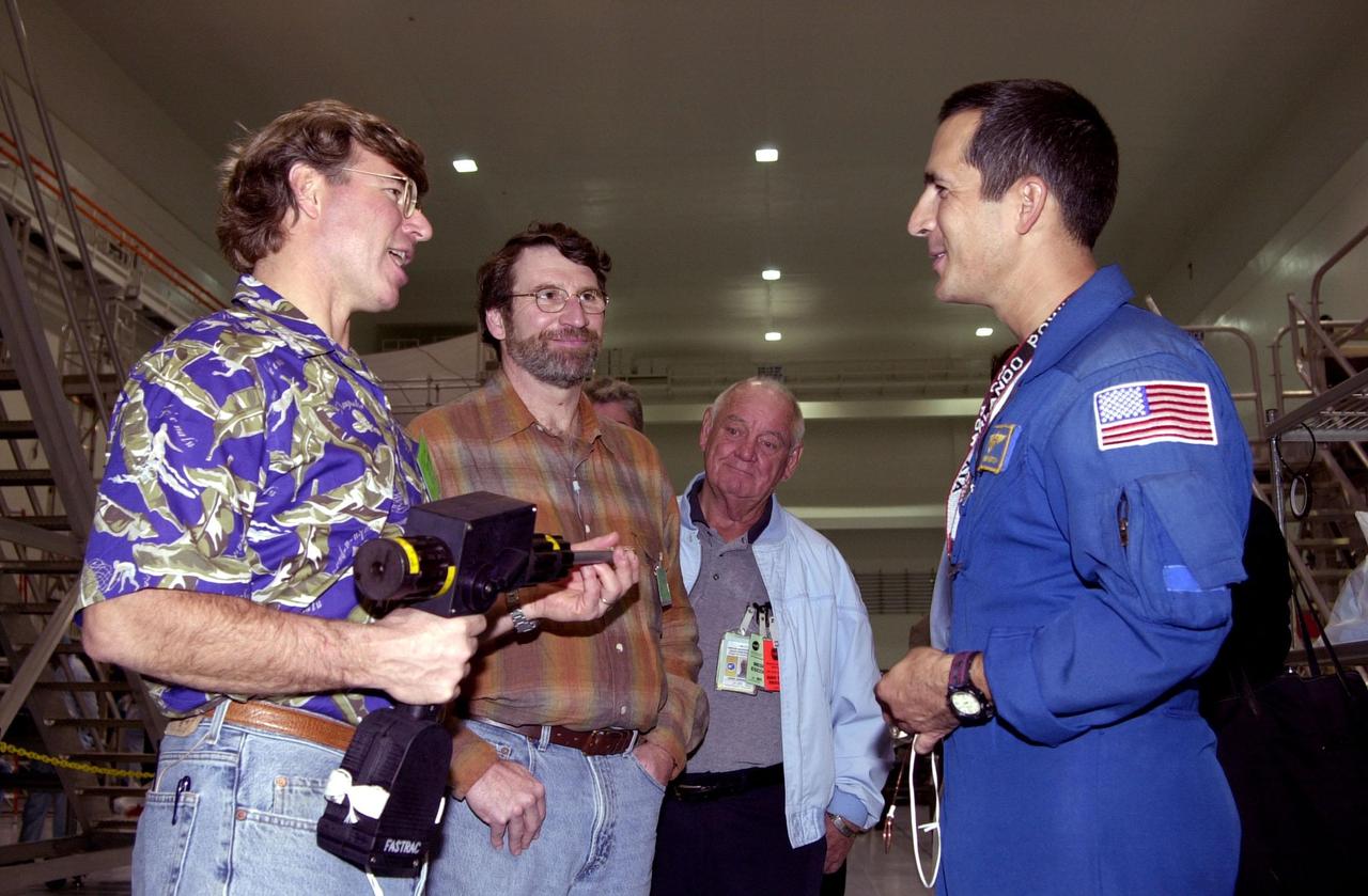 KENNEDY SPACE CENTER, FLA. -- Steve Thomas (left) and Norm Abram (second from left), who are seen in the television series "This Old House," talk with astronaut John Herrington (right). In the background is Johnny Johnson, media escort. Abram is at KSC to film an episode of "This Old House.