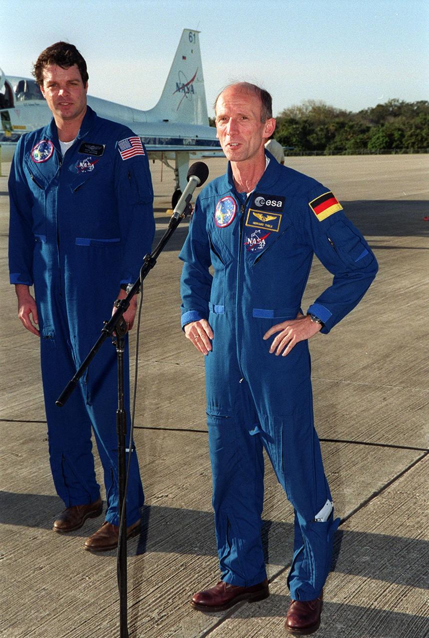 After their arrival at the Shuttle Landing Facility, the STS-99 crew talk to the media. At the microphone is Mission Specialist Gerhard Thiele, with the European Space Agency. At left is Commander Kevin Kregel. . The crew are here to take part in a Terminal Countdown Demonstration Test (TCDT), which provides simulated countdown exercises, emergency egress training, and opportunities to inspect the mission payloads in the orbiter's payload bay. Others taking part in the TCDT are Pilot Dominic Gorie and Mission Specialists Janice Voss (Ph.D.), Janet Lynn Kavandi (Ph.D.), Mamoru Mohri, who is with the National Space Development Agency (NASDA) of Japan. STS-99 is the Shuttle Radar Topography Mission, which will chart a new course, using two antennae and a 200-foot-long section of space station-derived mast protruding from the payload bay to produce unrivaled 3-D images of the Earth's surface. The result of the Shuttle Radar Topography Mission could be close to 1 trillion measurements of the Earth's topography. Besides contributing to the production of better maps, these measurements could lead to improved water drainage modeling, more realistic flight simulators, better locations for cell phone towers, and enhanced navigation safety. Launch of Endeavour on the 11-day mission is scheduled for Jan. 31 at 12:47 p.m. EST