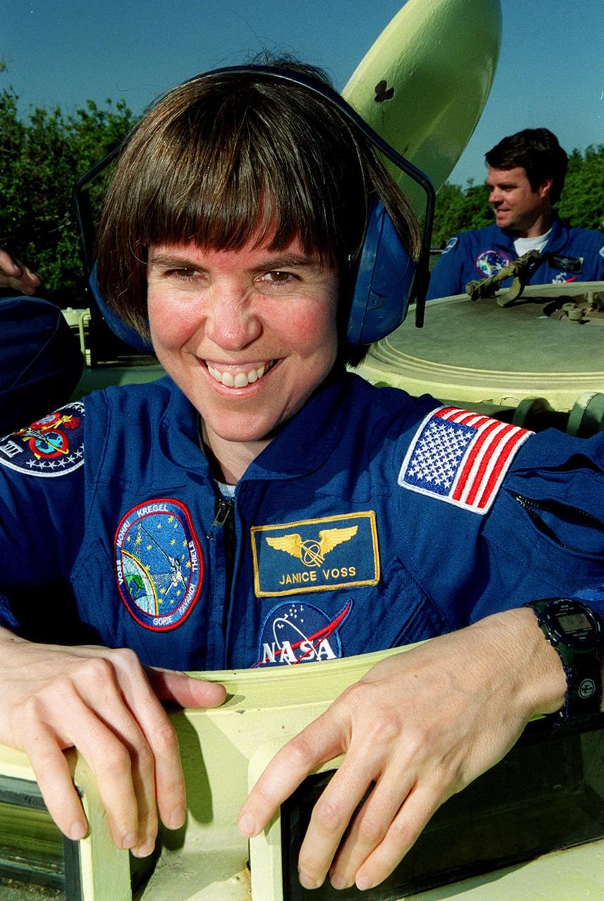 During Terminal Countdown Demonstration Test (TCDT) activities, STS-99 Mission Specialist Janice Voss (Ph.D.) is ready to practice driving the M-113, an armored personnel carrier. Part of Terminal Countdown Demonstration Test (TCDT) activities, the M-113 could be used by the crew in the event of an emergency at the pad during which the crew must make a quick exit from the area. In the rear (right) is Commander Kevin Kregel. TCDT provides the crew with simulated countdown exercises, emergency egress training, and opportunities to inspect the mission payloads in the orbiter's payload bay. STS-99 is the Shuttle Radar Topography Mission, which will chart a new course, using two antennae and a 200-foot-long section of space station-derived mast protruding from the payload bay to produce unrivaled 3-D images of the Earth's surface. The result of the Shuttle Radar Topography Mission could be close to 1 trillion measurements of the Earth's topography. Besides contributing to the production of better maps, these measurements could lead to improved water drainage modeling, more realistic flight simulators, better locations for cell phone towers, and enhanced navigation safety. Launch of Endeavour on the 11-day mission is scheduled for Jan. 31 at 12:47 p.m. EST