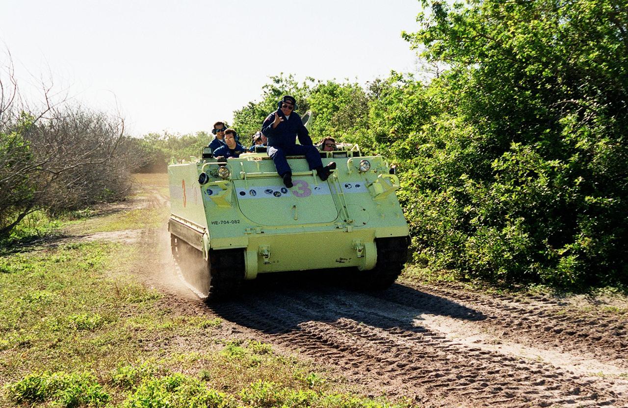 Under the watchful eye of Capt. George Hoggard, a trainer with the KSC Fire Department, STS-99 Commander Kevin Kregel practices driving the M-113, an armored personnel carrier. Part of Terminal Countdown Demonstration Test (TCDT) activities, the M-113 could be used by the crew in the event of an emergency at the pad during which the crew must make a quick exit from the area. TCDT provides the crew with simulated countdown exercises, emergency egress training, and opportunities to inspect the mission payloads in the orbiter's payload bay. STS-99 is the Shuttle Radar Topography Mission, which will chart a new course, using two antennae and a 200-foot-long section of space station-derived mast protruding from the payload bay to produce unrivaled 3-D images of the Earth's surface. The result of the Shuttle Radar Topography Mission could be close to 1 trillion measurements of the Earth's topography. Besides contributing to the production of better maps, these measurements could lead to improved water drainage modeling, more realistic flight simulators, better locations for cell phone towers, and enhanced navigation safety. Launch of Endeavour on the 11-day mission is scheduled for Jan. 31 at 12:47 p.m. EST