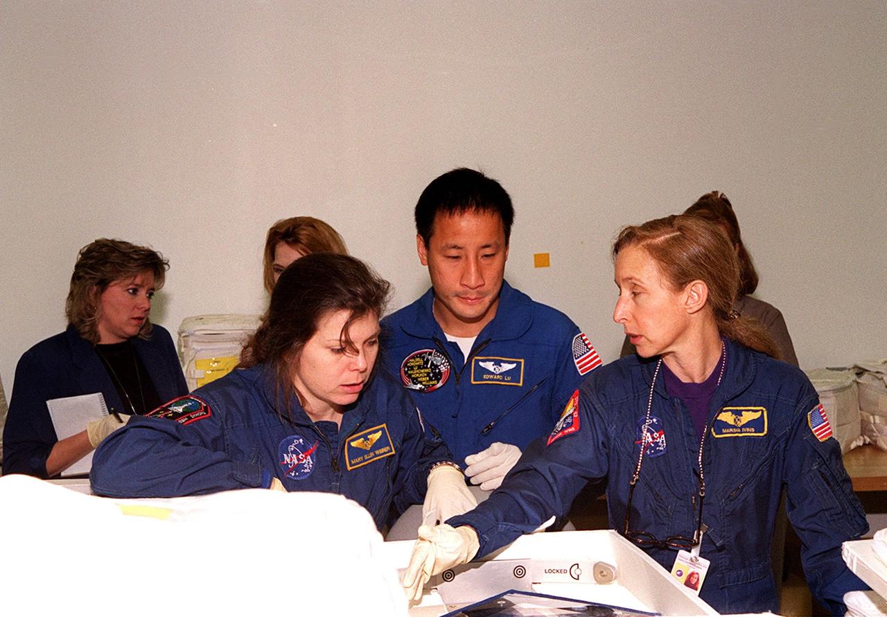 KENNEDY SPACE CENTER, FLA. -- At SPACEHAB, in Cape Canaveral, members of the STS-101 crew take part in a Crew Equipment Interface Test, which gives them an opportunity to look over equipment and payloads that will fly on the mission. In the foreground at left is Mission Specialist Mary Ellen Weber (Ph.D.), at center is Mission Specialist Edward Tsang Lu; at right is astronaut Marsha Ivins, who is assigned to mission STS-98 and is a veteran of five space flights. Her last flight, STS-81, including docking with the Russian Mir, and carrying the SPACEHAB double module to transfer tons of food and other cargo. On mission STS-101, Space Shuttle Atlantis will also be carrying the SPACEHAB Double Module, which will carry internal logistics and resupply cargo for station outfitting. Launch of Atlantis is scheduled no earlier than April 13, 2000
