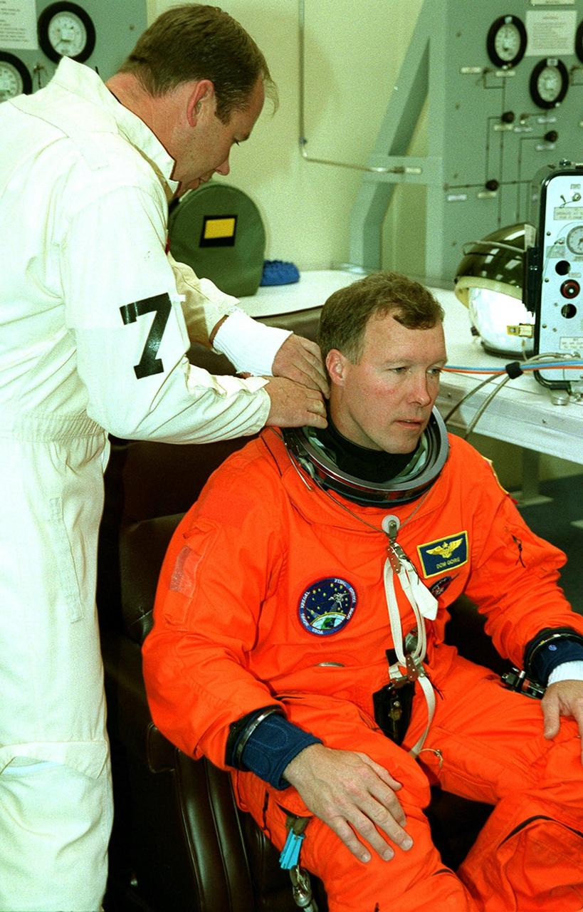 STS-99 Pilot Dominic Gorie suits up in the Operations and Checkout Building, as part of a flight crew equipment fit check, prior to his trip to Launch Pad 39A. The crew is taking part in Terminal Countdown Demonstration Test (TCDT) activities that provide the crew with simulated countdown exercises, emergency egress training, and opportunities to inspect the mission payloads in the orbiter's payload bay. STS-99 is the Shuttle Radar Topography Mission, which will chart a new course, using two antennae and a 200-foot-long section of space station-derived mast protruding from the payload bay to produce unrivaled 3-D images of the Earth's surface. The result of the Shuttle Radar Topography Mission could be close to 1 trillion measurements of the Earth's topography. Besides contributing to the production of better maps, these measurements could lead to improved water drainage modeling, more realistic flight simulators, better locations for cell phone towers, and enhanced navigation safety. Launch of Endeavour on the 11-day mission is scheduled for Jan. 31 at 12:47 p.m. EST
