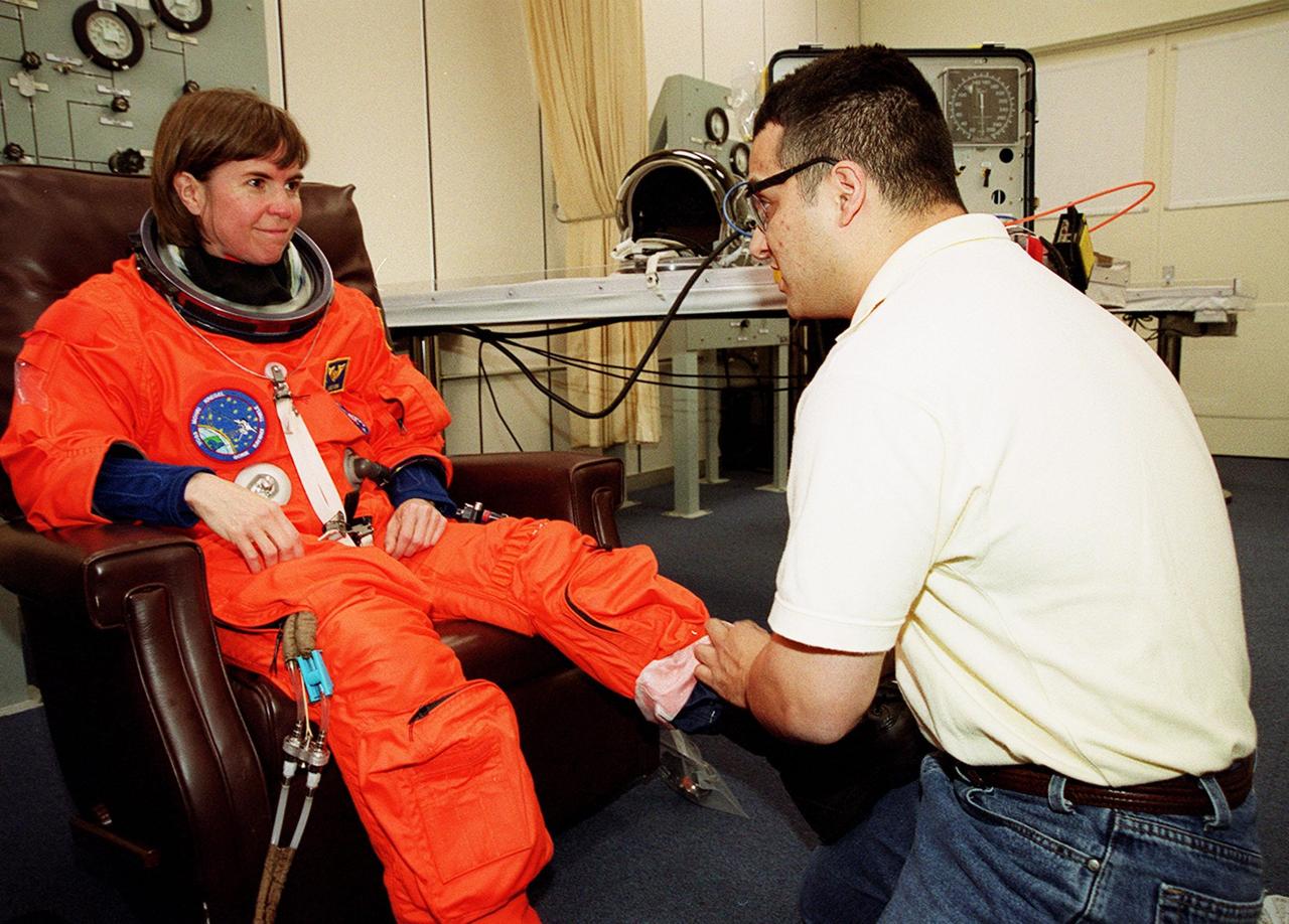 STS-99 Mission Specialist Janice Voss (Ph.D.) suits up in the Operations and Checkout Building, as part of a flight crew equipment fit check, prior to her trip to Launch Pad 39A. The crew is taking part in Terminal Countdown Demonstration Test (TCDT) activities that provide the crew with simulated countdown exercises, emergency egress training, and opportunities to inspect the mission payloads in the orbiter's payload bay. STS-99 is the Shuttle Radar Topography Mission, which will chart a new course, using two antennae and a 200-foot-long section of space station-derived mast protruding from the payload bay to produce unrivaled 3-D images of the Earth's surface. The result of the Shuttle Radar Topography Mission could be close to 1 trillion measurements of the Earth's topography. Besides contributing to the production of better maps, these measurements could lead to improved water drainage modeling, more realistic flight simulators, better locations for cell phone towers, and enhanced navigation safety. Launch of Endeavour on the 11-day mission is scheduled for Jan. 31 at 12:47 p.m. EST