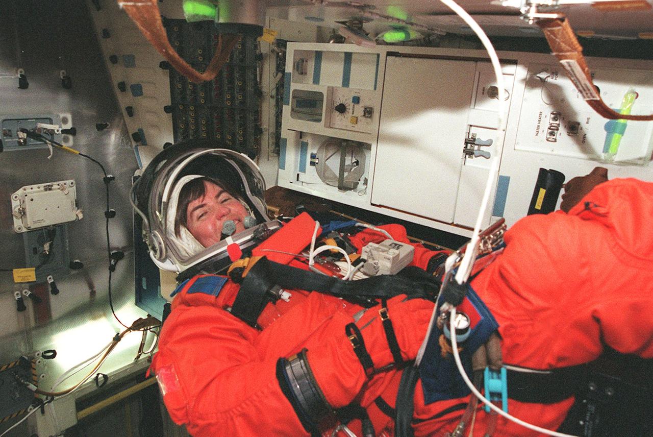 KENNEDY SPACE CENTER, FLA. -- STS-99 Mission Specialist Janice Voss (Ph.D.) settles into her seat inside Space Shuttle Endeavour for a practice launch countdown during Terminal Countdown Demonstration Test (TCDT) activities for the mission. The TCDT includes a simulation of the final launch countdown. STS-99 is the Shuttle Radar Topography Mission, which will chart a new course, using two antennae and a 200-foot-long section of the Space Station-derived mast protruding from the payload bay to produce unrivaled 3-D images of the Earth's surface. The result of the Shuttle Radar Topography Mission could be close to 1 trillion measurements of the Earth's topography. Besides contributing to the production of better maps, these measurements could lead to improved water drainage modeling, more realistic flight simulators, better locations for cell phone towers, and enhanced navigation safety. Launch of Endeavour on the 11-day mission is scheduled for Jan. 31 at 12:47 p.m. EST.