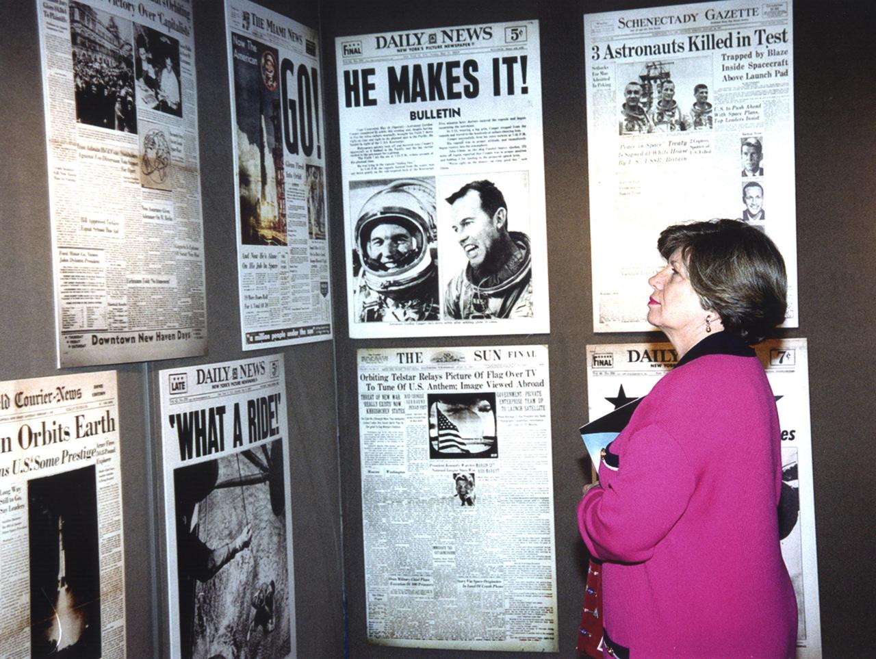 JoAnn Morgan, associate director for Advanced Development and Shuttle Upgrades at KSC, studies posters of space-related news stories in the mobile exhibition called &quot;NewsCapade with Al Neuharth.&quot; The exhibit started its cross-country tour in San Francisco in April. It is a traveling version of the Newseum in Arlington, Va. Morgan was among four speakers discussing &quot;Space, the Media and the Millennium&quot; at a reception Jan. 24 kicking off the display at KSC