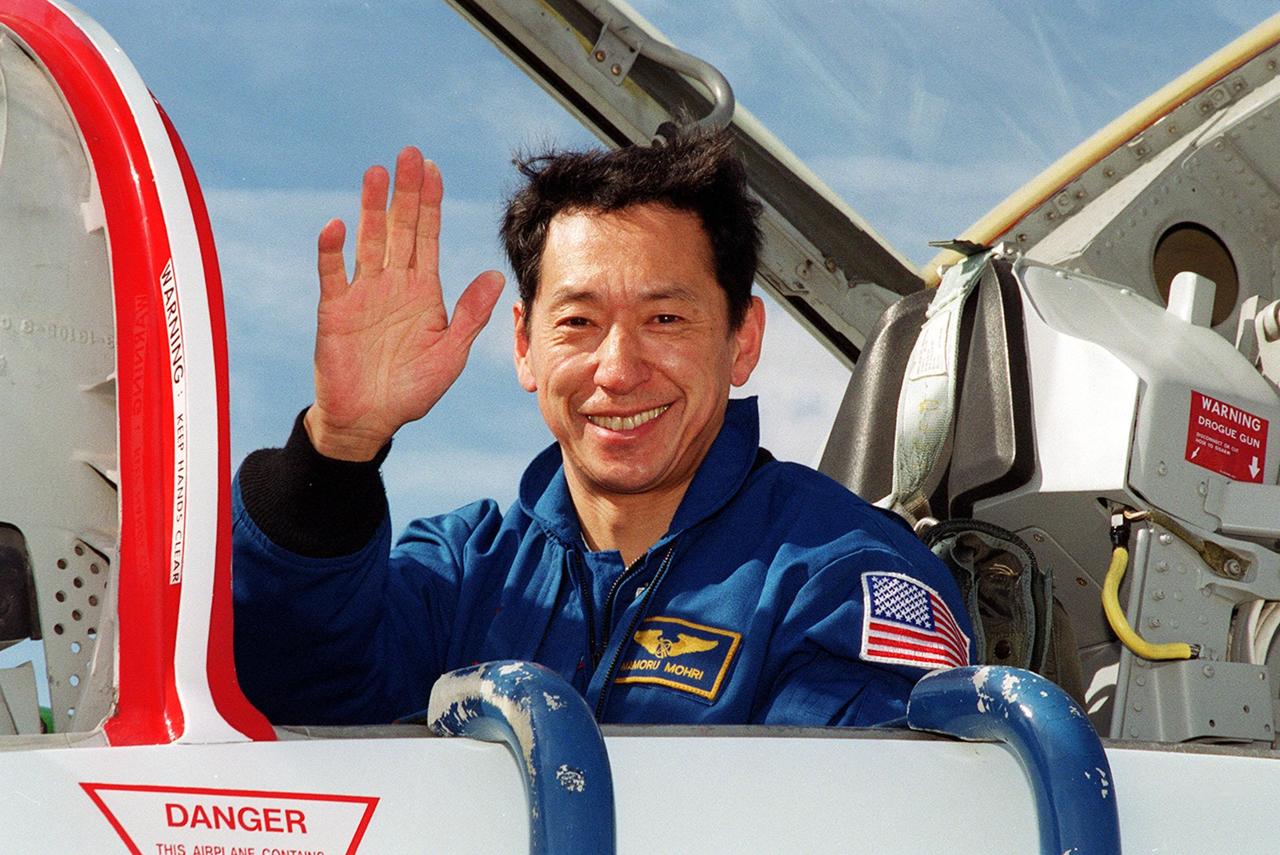 STS-99 Mission Specialist Mamoru Mohri (Ph.D.), who is with the National Space Development Agency (NASDA) of Japan, waves on his arrival at KSC aboard a T-38 jet aircraft to prepare for launch of Endeavour Jan. 31 at 12:47 p.m. EST. Over the next few days, the crew will review mission procedures, conduct test flights in the Shuttle Training Aircraft and undergo routine preflight medical exams. STS-99 is the Shuttle Radar Topography Mission, which will chart a new course, using two antennae and a 200-foot-long section of space station-derived mast protruding from the payload bay to produce unrivaled 3-D images of the Earth's surface. The result of the Shuttle Radar Topography Mission could be close to 1 trillion measurements of the Earth's topography. Besides contributing to the production of better maps, these measurements could lead to improved water drainage modeling, more realistic flight simulators, better locations for cell phone towers, and enhanced navigation safety
