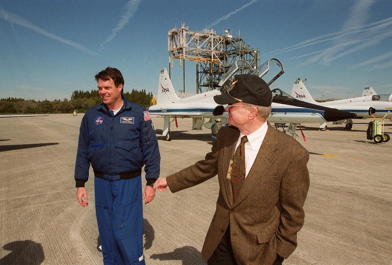 Center Director Roy Bridges (right) welcomes STS-99 Commander Kevin Kregel (left) and the rest of the crew after their arrival at KSC's Shuttle Landing Facility. Behind them are the T-38 jets that transported the crew, with the mate/demate tower in the background. Over the next few days, the crew will review mission procedures, conduct test flights in the Shuttle Training Aircraft and undergo routine preflight medical exams. STS-99 is the Shuttle Radar Topography Mission, which will chart a new course, using two antennae and a 200-foot-long section of space station-derived mast protruding from the payload bay to produce unrivaled 3-D images of the Earth's surface. The result of the Shuttle Radar Topography Mission could be close to 1 trillion measurements of the Earth's topography. Besides contributing to the production of better maps, these measurements could lead to improved water drainage modeling, more realistic flight simulators, better locations for cell phone towers, and enhanced navigation safety. Launch of Endeavour is scheduled for Jan. 31 at 12:47 p.m. EST