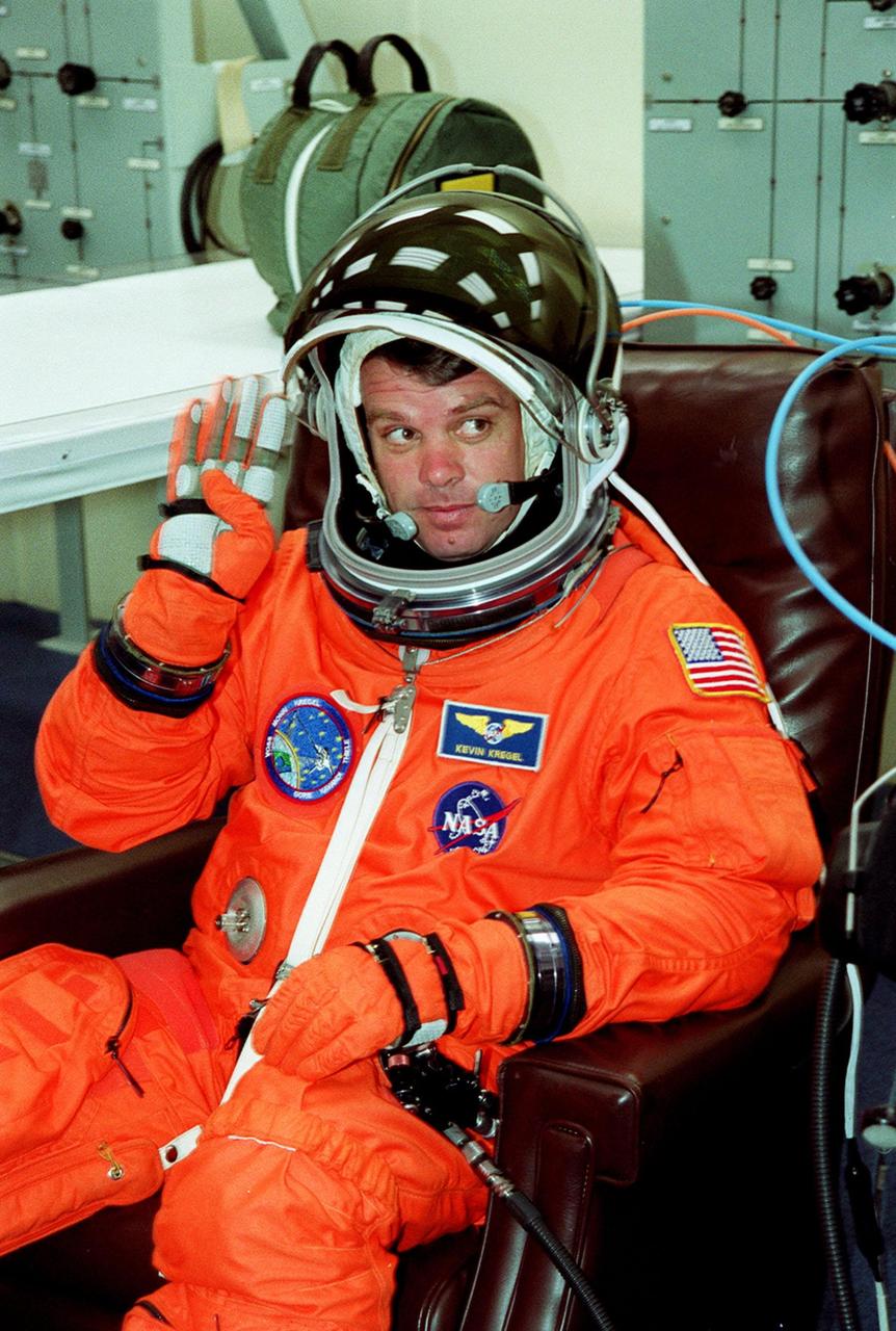 In the Operations and Checkout Building, STS-99 Commander Kevin Kregel waves as he suits up during final launch preparations. Liftoff of STS-99, known as the Shuttle Radar Topography Mission (SRTM), is scheduled for 12:47 p.m. EST from Launch Pad 39A. The SRTM will chart a new course to produce unrivaled 3-D images of the Earth's surface, using two antennae and a 200-foot-long section of space station-derived mast protruding from the payload bay. The result of the Shuttle Radar Topography Mission could be close to 1 trillion measurements of the Earth's topography. Besides contributing to the production of better maps, these measurements could lead to improved water drainage modeling, more realistic flight simulators, better locations for cell phone towers, and enhanced navigation safety. The mission is expected to last about 11days. Endeavour is expected to land at KSC Friday, Feb. 11, at 4:55 p.m. EST