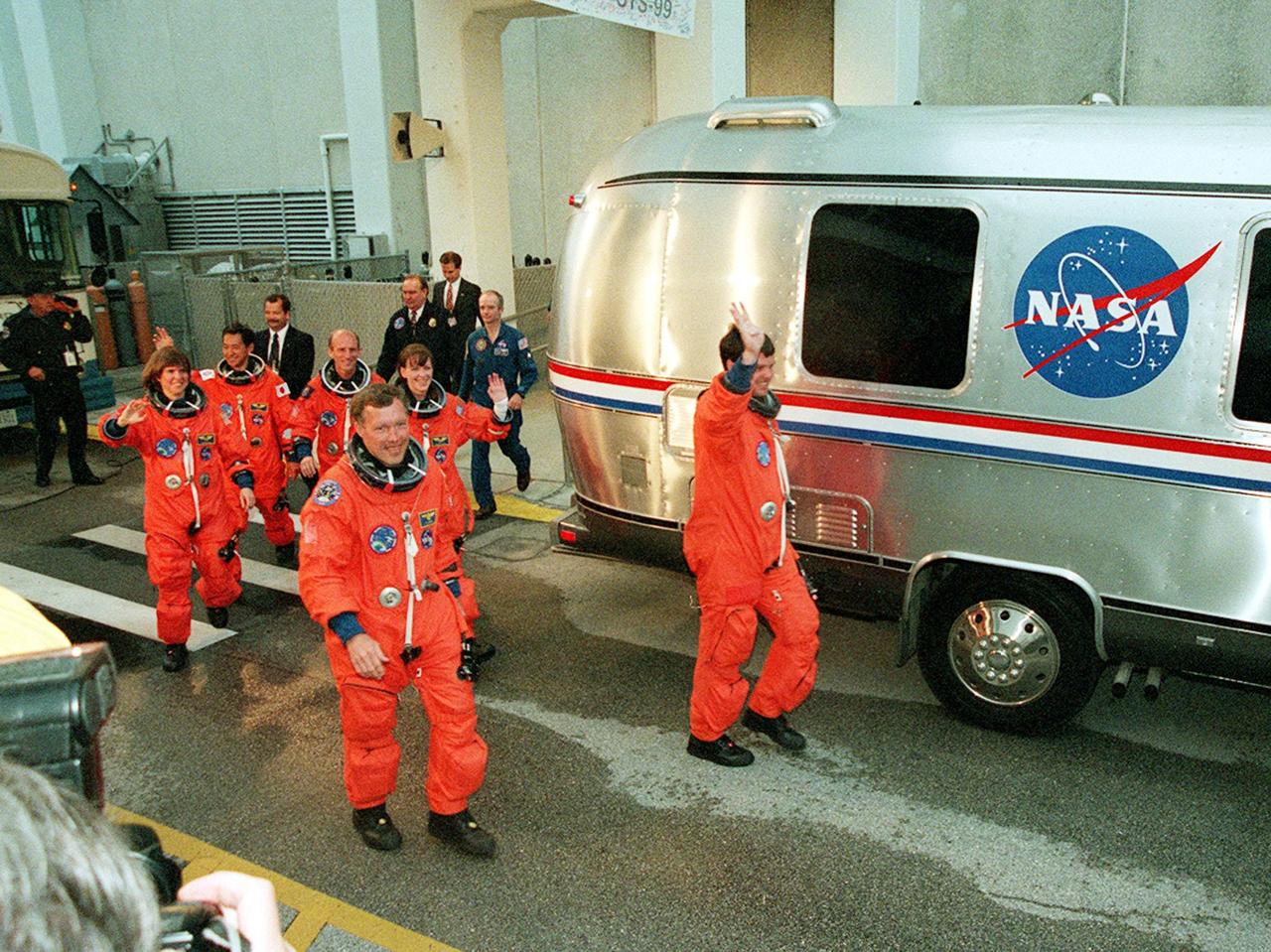 The STS-99 crew wave to onlookers as they walk to the astrovan which will take them to Launch Pad 39A and liftoff of Space Shuttle Endeavour, targeted for 12:47 p.m. EST. In their orange launch and entry suits, they are (foreground) Pilot Dominic Gorie and Commander Kevin Kregel. Behind them (left to right) are Mission Specialists Janice Voss (Ph.D.), Mamoru Mohri (Ph.D.), Gerhard Thiele and Janet Lynn Kavandi (Ph.D.). Mohri is with the National Space Development Agency (NASDA) of Japan, and Thiele is with the European Space Agency. The SRTM will chart a new course to produce unrivaled 3-D images of the Earth's surface, using two antennae and a 200-foot-long section of space station-derived mast protruding from the payload bay. The result of the Shuttle Radar Topography Mission could be close to 1 trillion measurements of the Earth's topography. Besides contributing to the production of better maps, these measurements could lead to improved water drainage modeling, more realistic flight simulators, better locations for cell phone towers, and enhanced navigation safety. The mission is expected to last about 11days, with Endeavour landing at KSC Friday, Feb. 11, at 4:55 p.m. EST