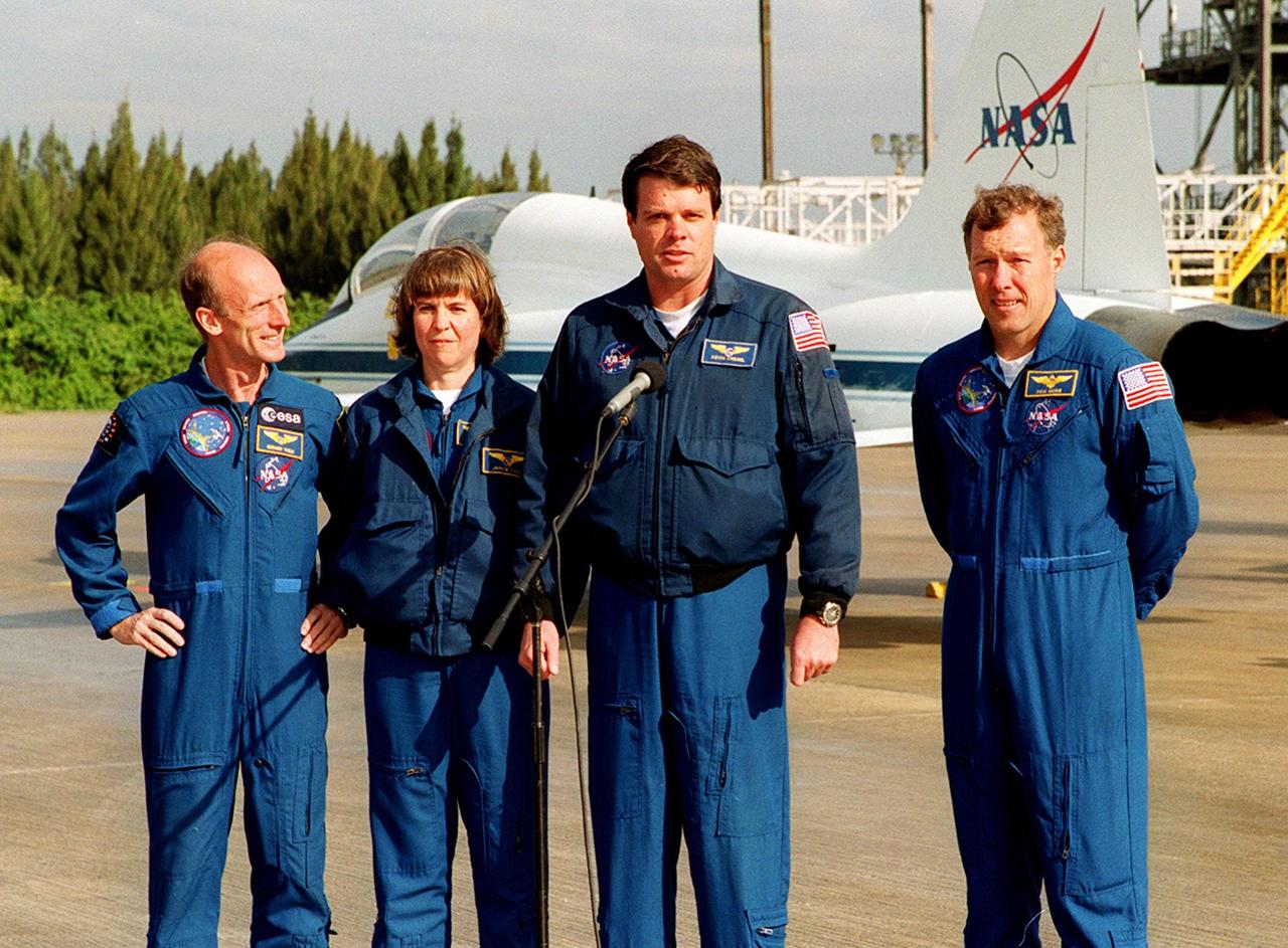 On the runway at the Shuttle Landing Facility, STS-99 crew members Mission Specialists Gerhard Thiele and Janice Voss, Commander Kevin Kregel and Pilot Dominic Gorie briefly talk to the media about their imminent departure to Houston. Kregel and Gorie will be piloting T-38 jets with Voss and Thiele as passengers. During the Jan. 31 launch countdown, Endeavour's enhanced master events controller (E-MEC) No. 2 failed a standard preflight test. Launch was postponed and Shuttle managers decided to replace the E-MEC located in the orbiter's aft compartment. Launch controllers will be in a position to begin the STS-99 countdown the morning of Feb. 6 and ready to support a launch midto late next week pending availability of the Eastern Range. The postponed launch gives the crew an opportunity for more training and time with their families. Known as the Shuttle Radar Topography Mission, it will chart a new course to produce unrivaled 3-D images of the Earth's surface, using two antennae and a 200-foot-long section of space station-derived mast protruding from the payload bay. The result could be close to 1 trillion measurements of the Earth's topography. Besides contributing to the production of better maps, these measurements could lead to improved water drainage modeling, more realistic flight simulators, better locations for cell phone towers, and enhanced navigation safety