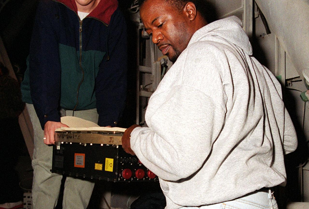 KENNEDY SPACE CENTER, FLA. -- Workers carry the replacement Enhanced Main Events Controller (E-MEC) to Shuttle Endeavour at Launch Pad 39A for installation in the aft compartment of the payload bay. The original E-MEC became suspect during the Jan. 31 launch countdown and mission STS-99 was delayed when NASA managers decided to replace it. Each Shuttle carries two enhanced master events controllers (E-MECs), which provide relays for onboard flight computers to send signals to arm and fire pyrotechnics that separate the solid rockets and external tank during assent. Both E-MECs are needed for the Shuttle to be cleared for flight. Currently Endeavour and Columbia are the only two orbiters with the E-MECs. Built by Rockwell's Satellite Space Electronics Division, Anaheim, Calif., each unit weighs 65 pounds and is approximately 20 inches long, 13 inches wide and 8 inches tall. Previously, three Shuttle flights have been scrubbed or delayed due to faulty MECs: STS-73, STS-49 and STS-41-D. The next scheduled date for launch of STS-99 is Feb. 11 at 12:30 p.m. EST