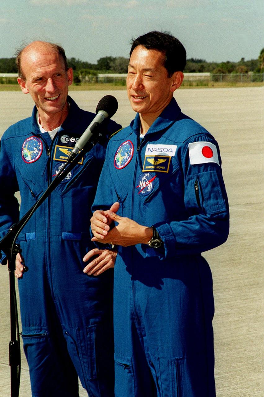 After landing at the Shuttle Landing Facility aboard T-38 jet aircraft, the STS-99 crew addressed the media. Mission Specialists Gerhard Thiele of Germany waits while Mamoru Mohri of Japan (right) responds to a question. The crew is ready to prepare for the second launch attempt of Endeavour Feb. 11 at 12:30 p.m. EST from Launch Pad 39A. The earlier launch scheduled for Jan. 31 was scrubbed due to poor weather and a faulty Enhanced Master Events Controller in the orbiter's aft compartment. Over the next few days, the crew will review mission procedures, conduct test flights in the Shuttle Training Aircraft and undergo routine preflight medical exams. STS-99 is the Shuttle Radar Topography Mission, which will produce unrivaled 3-D images of the Earth's surface. The result of the Shuttle Radar Topography Mission could be close to 1 trillion measurements of the Earth's topography. Landing is expected at KSC on Feb. 22 at 4:36 p.m. EST
