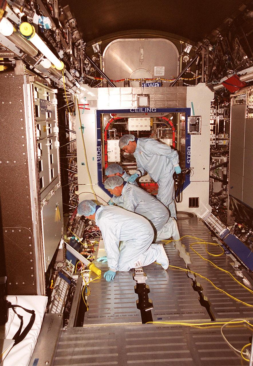 Members of the STS-98 crew check out equipment in the U.S. Lab Destiny during a Multi-Equipment Interface Test. During the mission, the crew will install the Lab in the International Space Station during a series of three space walks. The STS-98 mission will provide the station with science research facilities and expand its power, life support and control capabilities. The U.S. Laboratory Module continues a long tradition of microgravity materials research, first conducted by Skylab and later Shuttle and Spacelab missions. Destiny is expected to be a major feature in future research, providing facilities for biotechnology, fluid physics, combustion, and life sciences research. Making up the five-member crew on STS-98 are Commander Kenneth D. Cockrell, Pilot Mark L. Polansky, and Mission Specialists Robert L. Curbeam Jr., Thomas D. Jones (Ph.D.) and Marsha S. Ivins. The Lab is planned for launch aboard Space Shuttle Atlantis on the sixth ISS flight, currently targeted no earlier than Aug. 19, 2000