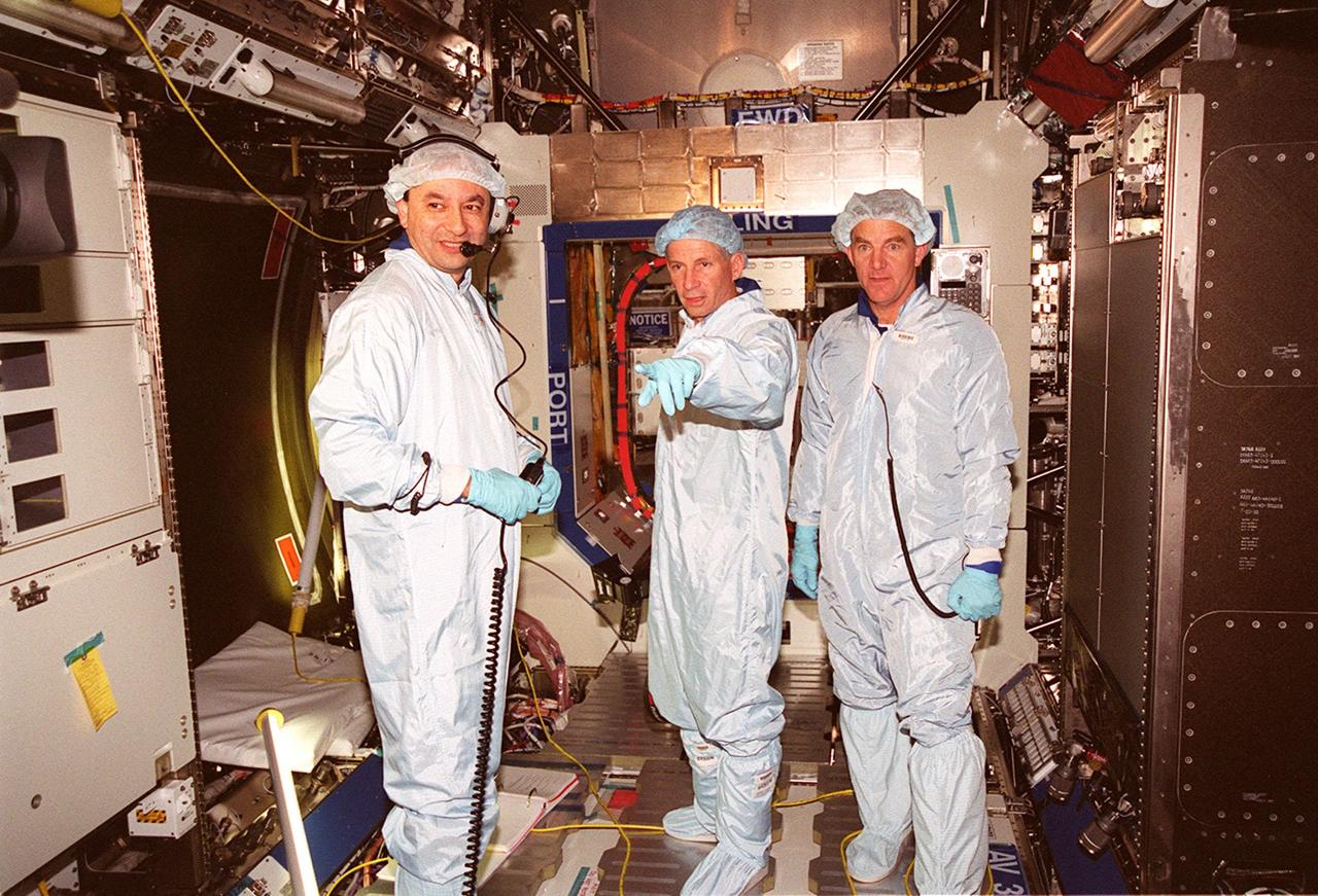 Looking over equipment inside the U.S. Lab Destiny as part of a Multi-Equipment Interface Test are STS-98 Pilot Mark Polansky (left) and Commander Kenneth D. Cockrell (center). They are joined by astronaut James Voss (right), who will be among the first crew to inhabit the International Space Station on a flight in late 2000. During the STS-98 mission, the crew will install the Lab on the station during a series of three space walks. The mission will provide the station with science research facilities and expand its power, life support and control capabilities. The U.S. Laboratory Module continues a long tradition of microgravity materials research, first conducted by Skylab and later Shuttle and Spacelab missions. Destiny is expected to be a major feature in future research, providing facilities for biotechnology, fluid physics, combustion, and life sciences research. Others in the five-member crew on STS-98 are Mission Specialists Robert L. Curbeam Jr., Thomas D. Jones (Ph.D.) and Marsha S. Ivins. The Lab is planned for launch aboard Space Shuttle Atlantis on the sixth ISS flight, currently targeted no earlier than Aug. 19, 2000