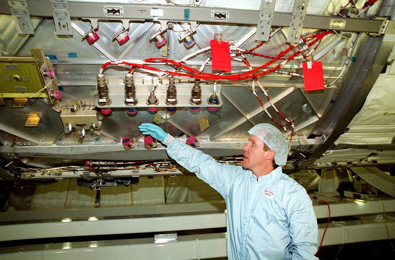 In the Space Station Processing Facility, STS-98 Mission Specialist Thomas D. Jones (Ph.D.) looks at electrical connections on the U.S. Lab Destiny as part of a Multi-Equipment Interface Test (MEIT). Other crew members taking part in the MEIT are Commander Kenneth D. Cockrell and Pilot Mark Polansky. The remaining members of the crew (not present for the MEIT) are Mission Specialists Robert L. Curbeam Jr. and Marsha S. Ivins. During the STS-98 mission, the crew will install the Lab on the International Space Station during a series of three space walks. The mission will provide the station with science research facilities and expand its power, life support and control capabilities. The U.S. Laboratory Module continues a long tradition of microgravity materials research, first conducted by Skylab and later Shuttle and Spacelab missions. Destiny is expected to be a major feature in future research, providing facilities for biotechnology, fluid physics, combustion, and life sciences research. The Lab is planned for launch aboard Space Shuttle Atlantis on the sixth ISS flight, currently targeted no earlier than Aug. 19, 2000