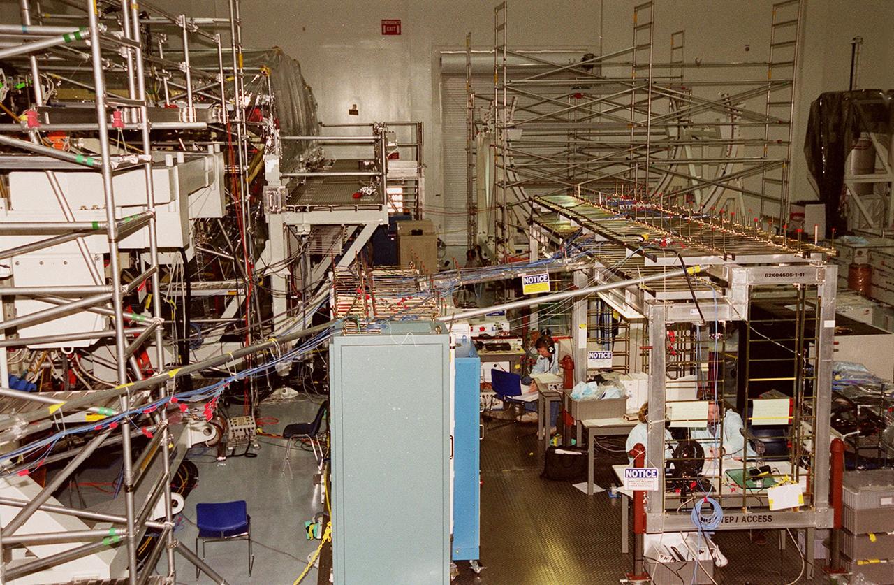 The Space Station Processing Facility (SSPF) appears overflowing with racks and wires being used to support work on elements of the International Space Station. Currently housed in the SSPF are the U.S. Lab Destiny and the Multi-Purpose Logistics Modules Leonardo and Raffaello. Destiny, element 5A of the station, is scheduled for launch on mission STS-98 in August; Leonardo, element 5A.1, on mission STS-102 in October; and Raffaello, element 6A, on mission STS-100 in November
