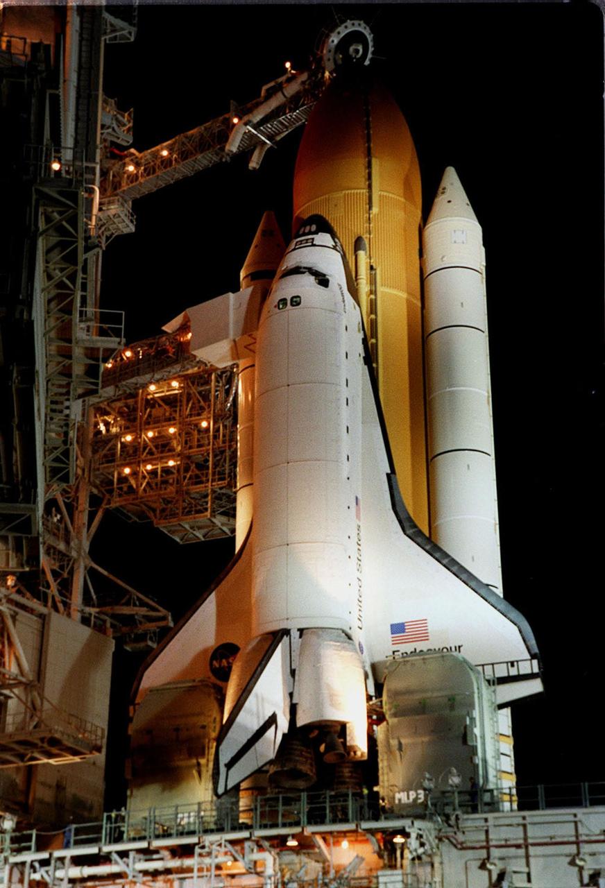 KENNEDY SPACE CENTER, Fla.  --  After the rollback of the Rotating Service Structure on Launch Pad 39A, Space Shuttle Endeavour is marked with shadows from the lights on the Fixed Service Structure. Above the orange external tank is the Gaseous Oxygen Vent Hood, often called the "beanie cap," waiting to be lowered. The hood helps vent gaseous oxygen vapors away from the Space Shuttle until launch, when it is raised and retracted two and a half minutes before liftoff. Endeavour waits for mission STS-99, known as the Shuttle Radar Topography Mission (SRTM), which will chart a new course to produce unrivaled 3-D images of the Earth's surface. The result of the SRTM could be close to 1 trillion measurements of the Earth's topography. The mission is expected to last 11days, with Endeavour landing at KSC Tuesday, Feb. 22, at 4:36 p.m. EST. This is the 97th Shuttle flight and 14th for Shuttle Endeavour