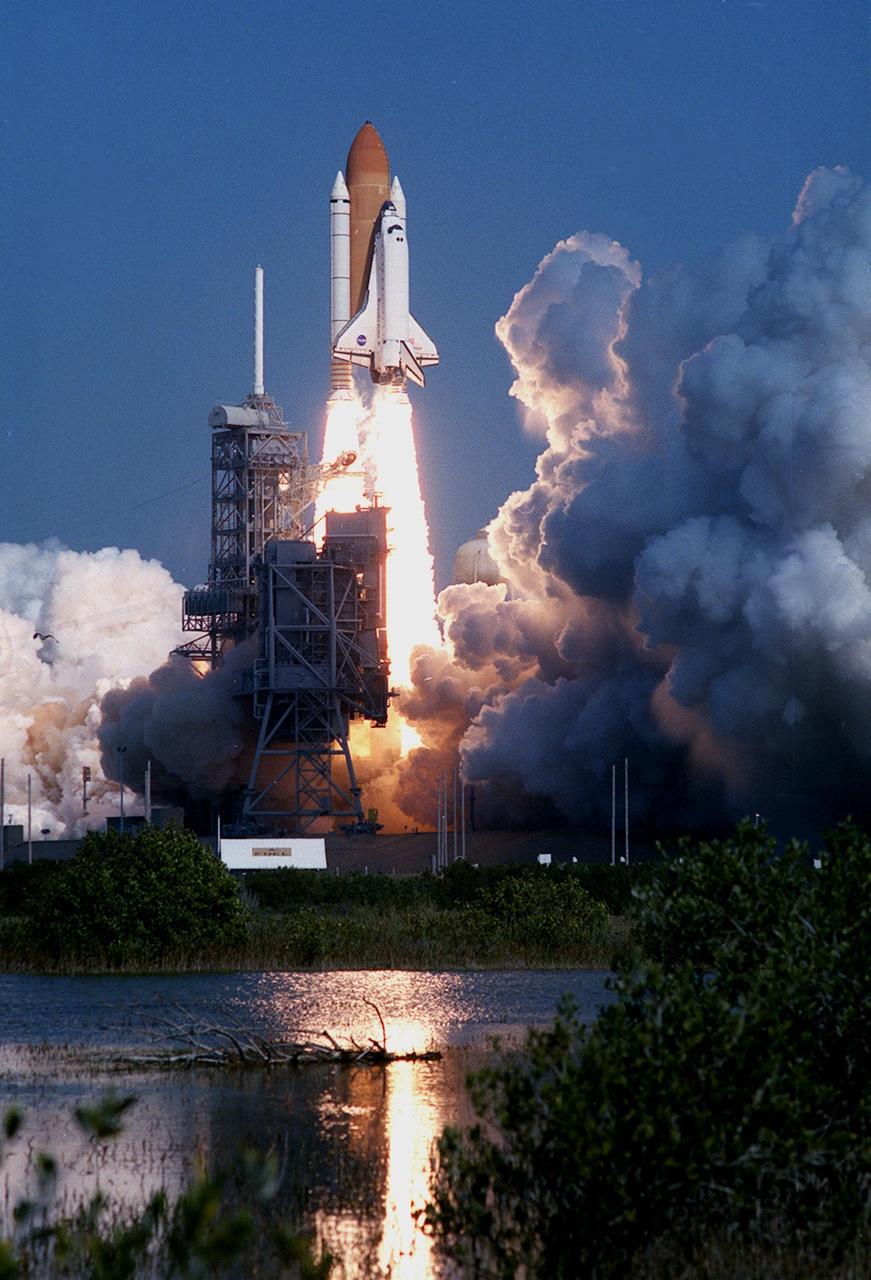 KENNEDY SPACE CENTER, Fla.  --  The water below Launch Pad 39A reflects the perfect launch of Space Shuttle Endeavour on mission STS-99, while nearby billows of cloud and smoke are tinged with shadows. Launch of Endeavour occurred at 12:43:40 p.m. EST with a crew of five aboard: Commander Kevin Kregel, Pilot Dominic Gorie, and Mission Specialists Janet Kavandi, Janice Voss, Mamoru Mohri of Japan and Gerhard Thiele of Germany. Mohri is with the National Space Development Agency (NASDA) of Japan, and Thiele is with the European Space Agency. Known as the Shuttle Radar Topography Mission (SRTM), STS-99 will chart a new course to produce unrivaled 3-D images of the Earth's surface. The result of the SRTM could be close to 1 trillion measurements of the Earth's topography. The mission is expected to last 11days, with Endeavour landing at KSC Tuesday, Feb. 22, at 4:36 p.m. EST. This is the 97th Shuttle flight and 14th for Shuttle Endeavour