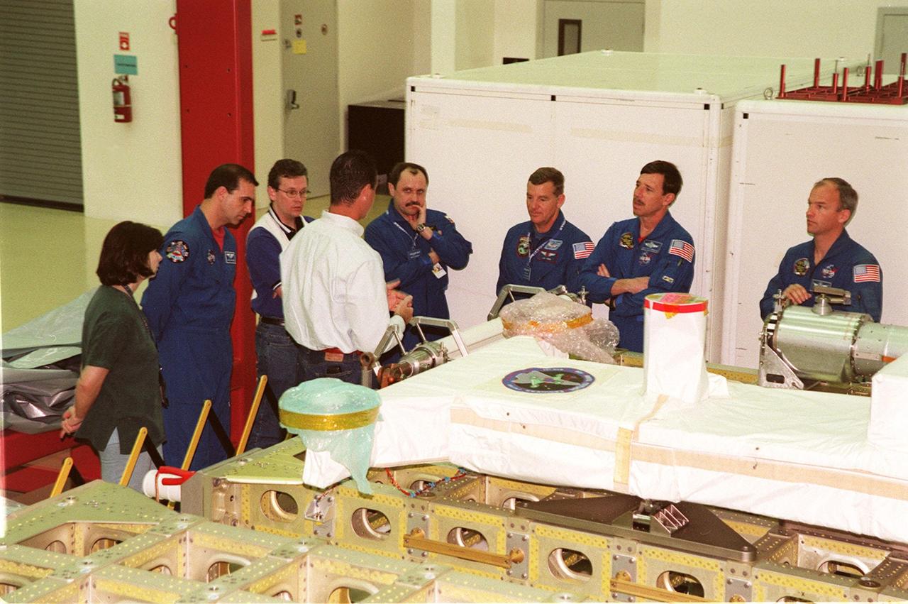 KENNEDY SPACE CENTER, FLA. -- At SPACEHAB, in Cape Canaveral, Fla., members of the STS-101 crew and STS-106 crew take part in Crew Equipment Interface Test activities, learning from technicians in the facility about some of the equipment they will be working with on their mission to the International Space Station. From left are Claudia Melchiorre, who is with DASA, Daimler-Chrysler Aerospace; STS-106 Mission Specialist Richard Mastracchio; a SPACEHAB worker; Marty McLellan, director of ground operations; Mission Specialists Yuri Usachev of Russia and James Voss; Pilot Scott Horowitz; and Mission Specialist Jeffrey Williams. Other members of the STS-101 crew (not shown) are Mission Specialists Mary Ellen Weber and Susan Helms. The ST-101 crew will be responsible for preparing the Space Station for the arrival of the Zvezda Service Module, expected to be launched by Russia in July 2000. Also, the crew will conduct one space walk to perform maintenance on the Space Station and deliver logistics and supplies. This will be the third assembly flight for the Space Station. STS-101 is scheduled to launch no earlier than April 13 from Launch Pad 39A
