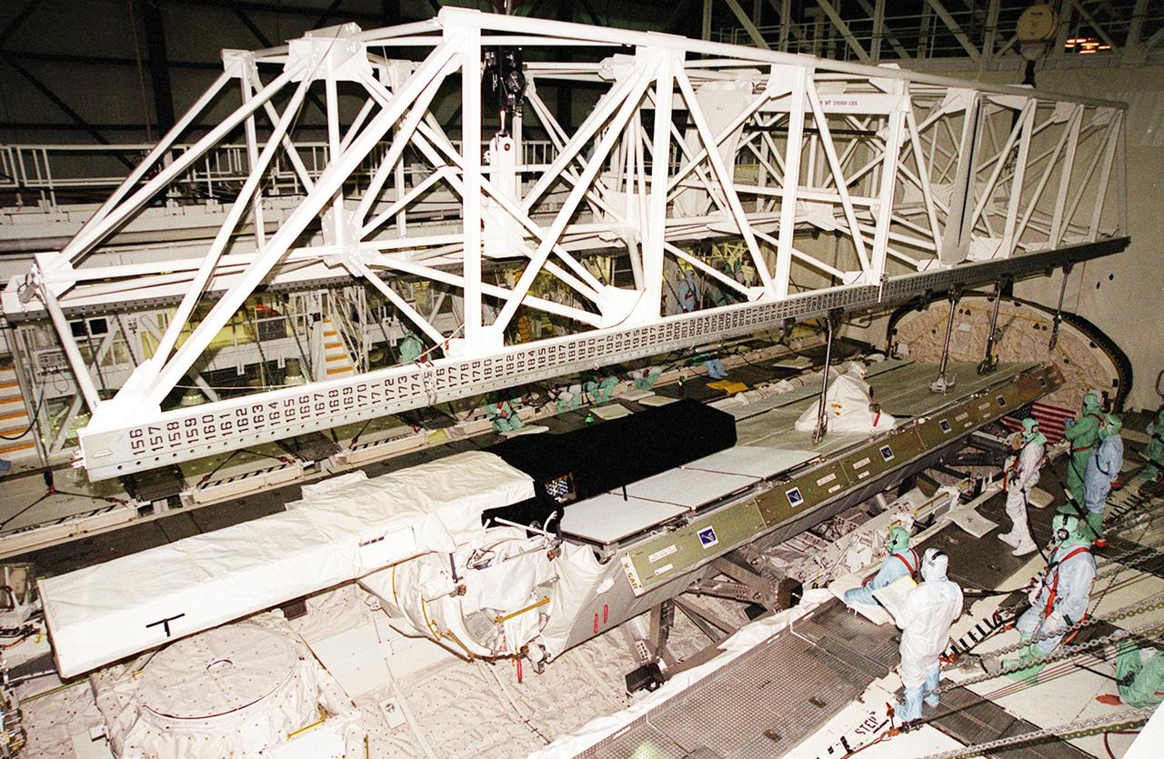 In OPF bay 2, the Shuttle Radar Topography Mission (SRTM) payload is lifted out of Endeavour's payload bay for transport to the Space Station Processing Facility. The SRTM mapped more than 47 million square miles of the Earth's surface on mission STS-99, which landed Feb. 22, 2000