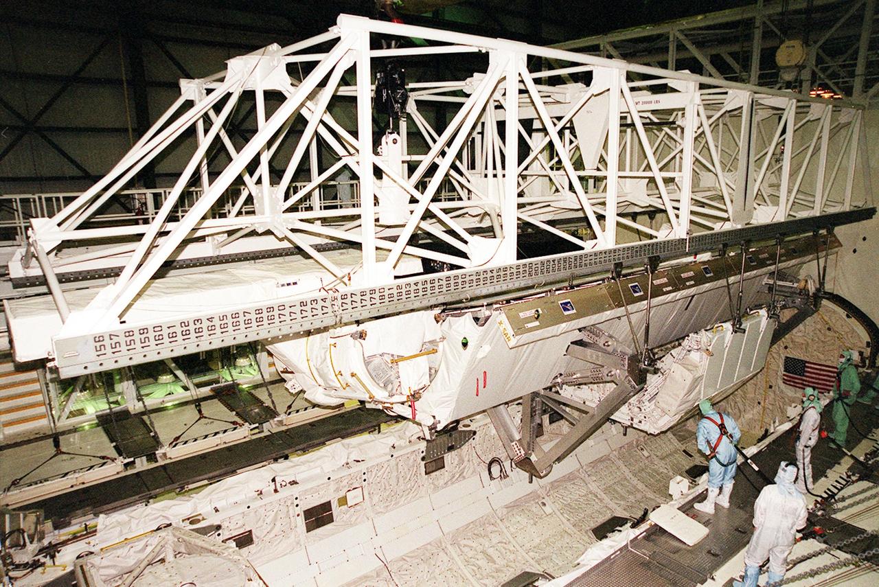 In OPF bay 2, an overhead crane lifts the Shuttle Radar Topography Mission (SRTM) payload out of Endeavour's payload bay for transport to the Space Station Processing Facility. The SRTM mapped more than 47 million square miles of the Earth's surface on mission STS-99, which landed Feb. 22, 200