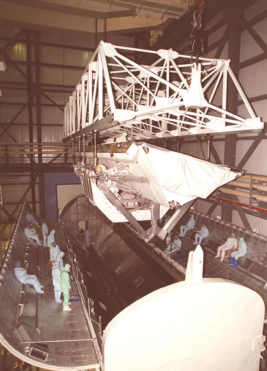 KENNEDY SPACE CENTER, FLA. -- In OPF bay 2, after lifting the Shuttle Radar Topography Mission (SRTM) payload out of Endeavour's payload bay, a crane moves it into a payload canister for transport to the Space Station Processing Facility. The SRTM mapped more than 47 million square miles of the Earth's surface on mission STS-99, which landed Feb. 22, 2000