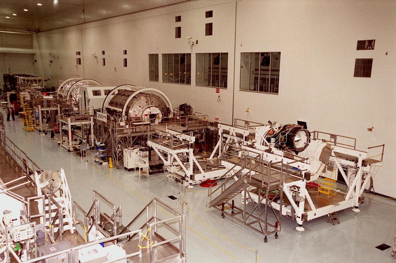 KENNEDY SPACE CENTER, FLA. -- The Space Station Processing Facility is filled with hardware, components for the International Space Station. Lined up (left to right) are the Multi-Purpose Logistics Modules Raffaello and Leonardo and the Pressurized Mating Adapter-3 (PMA-3). Italy's major contributions to the ISS program, Raffaello and Leonardo are reusable logistics carriers to resupply and return station cargo requiring a pressurized environment. They are slated as payloads on missions STS-102 and STS-100, respectively. Dates have not yet been determined for the two missions. The PMA-3, once launched, will be mated to Node 1, a connecting passageway to the living and working areas of the Space Station. The primary purpose of PMA-3 is to serve as a Shuttle docking port through which crew members and equipment will transfer to the Space Station during later assembly missions. PMA-3 is scheduled as payload on mission STS-92, whose date for launch is not yet determined.