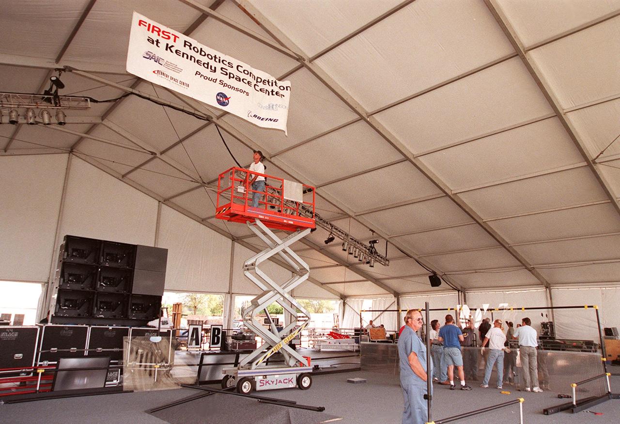 Workers at the Kennedy Space Center Visitor Complex make final preparations in the huge tent for the FIRST (For Inspiration and Recognition of Science and Technology) Southeast Regional competition March 9-11. Teams of high school students are testing the limits of their imagination using robots they have designed, with the support of business and engineering professionals and corporate sponsors, to compete in a technological battle against other schools' robots. Of the 30 high school teams competing at KSC, 16 are Florida teams co-sponsored by NASA and KSC contractors. Local high schools participating are Astronaut, Bayside, Cocoa Beach, Eau Gallie, Melbourne, Melbourne Central Catholic, Palm Bay, Rockledge, Satellite, and Titusville