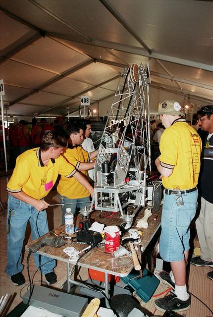 Voltage: The South Brevard FIRST Team (386) works on their robot, Sparky. The team of students from Eau Gallie, Satellite, Palm Bay, Melbourne, Bayside and Melbourne Central Catholic high schools was co-sponsored by Intersil Corp., Harris Corp., NASA Kennedy Space Center, Rockwell Collins and Interface &amp; Control Systems, Inc. Students from all over the country are at the KSC Visitor Complex for the FIRST (For Inspiration and Recognition of Science and Technology) Southeast Regional competition March 9-11 in the Rocket Garden. Teams of high school students are testing the limits of their imagination using robots they have designed, with the support of business and engineering professionals and corporate sponsors, to compete in a technological battle against other schools' robots. Of the 30 high school teams competing, 16 are Florida teams co-sponsored by NASA and KSC contractors. Local high schools participating are Astronaut, Bayside, Cocoa Beach, Eau Gallie, Melbourne, Melbourne Central Catholic, Palm Bay, Rockledge, Satellite, and Titusville