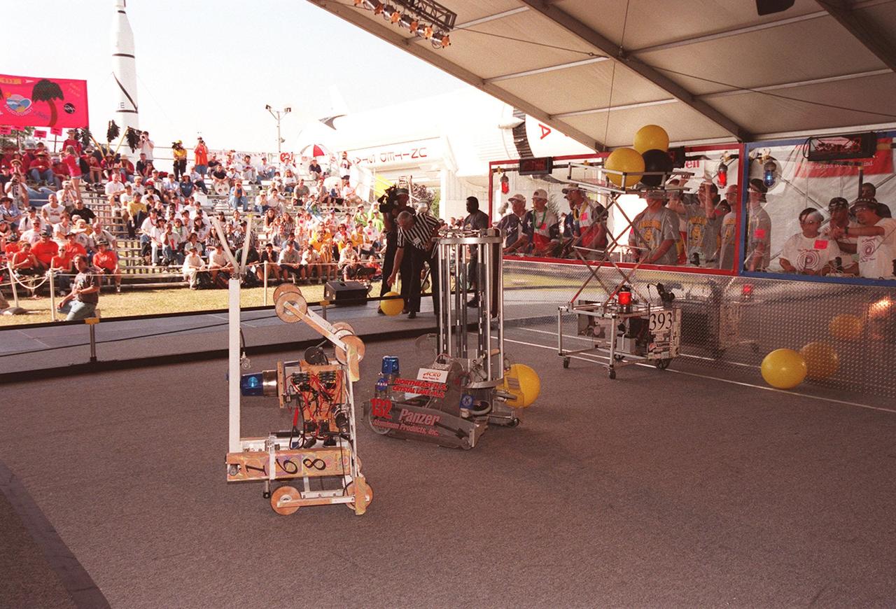 FIRST teams and their robots work to go through the right motions at the FIRST competition. Students from all over the country are at the KSC Visitor Complex for the FIRST (For Inspiration and Recognition of Science and Technology) Southeast Regional competition March 9-11 in the Rocket Garden. Teams of high school students are testing the limits of their imagination using robots they have designed, with the support of business and engineering professionals and corporate sponsors, to compete in a technological battle against other schools' robots. Of the 30 high school teams competing, 16 are Florida teams co-sponsored by NASA and KSC contractors. Local high schools participating are Astronaut, Bayside, Cocoa Beach, Eau Gallie, Melbourne, Melbourne Central Catholic, Palm Bay, Rockledge, Satellite, and Titusville