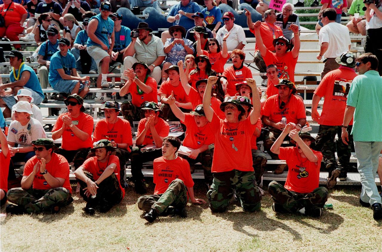 Members of the FIRST robotic team, ComBBat, from Central Florida's Astronaut and Titusville high schools, cheer and encourage the contestants during competition. Students from all over the country are at the KSC Visitor Complex for the FIRST (For Inspiration and Recognition of Science and Technology) Southeast Regional competition March 9-11 in the Rocket Garden. Teams of high school students are testing the limits of their imagination using robots they have designed, with the support of business and engineering professionals and corporate sponsors, to compete in a technological battle against other schools' robots. Of the 30 high school teams competing, 16 are Florida teams co-sponsored by NASA and KSC contractors. Local high schools participating are Astronaut, Bayside, Cocoa Beach, Eau Gallie, Melbourne, Melbourne Central Catholic, Palm Bay, Rockledge, Satellite, and Titusville