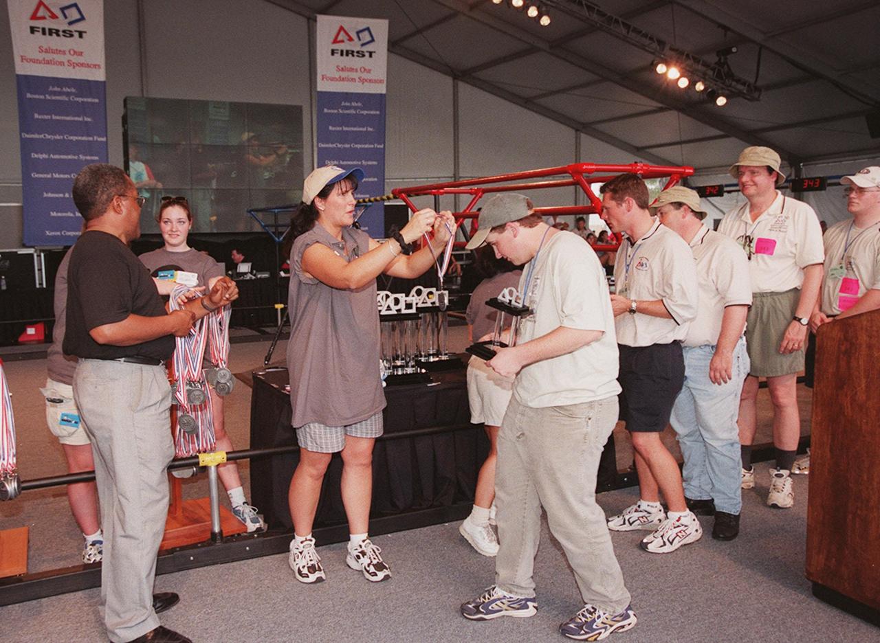 Members of one of the teams competing in the FIRST (For Inspiration and Recognition of Science and Technology) Southeast Regional competition, wait to receive their medals from the FIRST crew. At left is Nap Carroll, chief financial officer, Kennedy Space Center. The event was held at the KSC Visitor Complex. Teams of high school students from all over the country tested the limits of their imagination using robots they designed, with the support of business and engineering professionals and corporate sponsors, to compete in a technological battle against other schools' robots. Of the 30 high school teams competing at the Southeast Regional event, 16 were Florida teams co-sponsored by NASA and KSC contractors. Local high schools participating are Astronaut, Bayside, Cocoa Beach, Eau Gallie, Melbourne, Melbourne Central Catholic, Palm Bay, Rockledge, Satellite, and Titusville