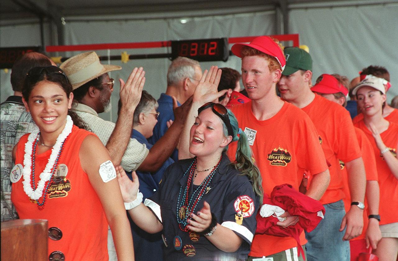 Members of the team known as Heatwave, from St. Petersburg, Fla., get "high fives" from Jim Jennings (wearing a straw hat), KSC's deputy director for Business Operations, during closing ceremonies for the FIRST (For Inspiration and Recognition of Science and Technology) Southeast Regional competition held at the KSC Visitor Complex. Heatwave came in second for the final competition, plus received awards for Number One Seed, Best Offensive round, and the DaimlerChrysler Team Spirit. Teams of high school students from all over the country tested the limits of their imagination using robots they designed, with the support of business and engineering professionals and corporate sponsors, to compete in a technological battle against other schools' robots. Of the 30 high school teams competing at the Southeast Regional event, 16 were Florida teams co-sponsored by NASA and KSC contractors. Local high schools participating are Astronaut, Bayside, Cocoa Beach, Eau Gallie, Melbourne, Melbourne Central Catholic, Palm Bay, Rockledge, Satellite, and Titusville