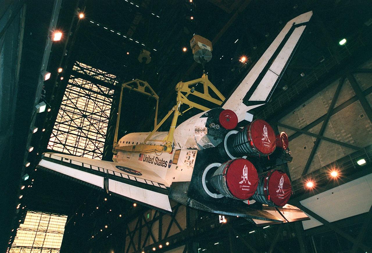 KENNEDY SPACE CENTER, FLA. -- Inside the Vehicle Assembly Building, orbiter Atlantis is lifted toward a vertical position in the transfer aisle. The 122-foot long orbiter is easily accommodated inside the 525-foot-tall, 518-foot-wide VAB. Once in position, Atlantis will be mated with its external tank and solid rocket boosters before being transported to Launch Pad 39A. Atlantis will fly on mission STS-101 to the International Space Station, where its crew of seven will prepare the Station for the arrival of the next pressurized module, the Russian-built Zvezda. Atlantis is expected to launch no earlier than April 17, 2000