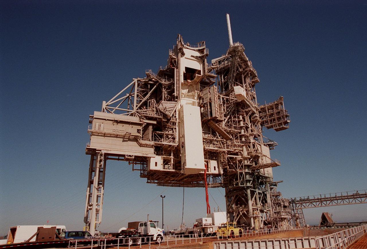 KENNEDY SPACE CENTER, FLA. -- At Launch Pad 39A, the payload canister with the SPACEHAB Double Module and Integrated Cargo Carrier (ICC) inside is lifted up the Rotating Service Structure (RSS) toward the Payload Changeout Room, an environmentally controlled facility supporting cargo delivery to the pad and vertical installation in the orbiter cargo bay. At right of the RSS is the Fixed Service Structure, topped by the 80-foot-tall fiberglass lightning mast. The primary payload on mission STS-101, the module and ICC contain internal logistics and resupply cargo for restoring full redundancy to the International Space Station power system in preparation for the arrival of the next pressurized module, the Russian-built Zvezda. The payloads will be transferred to Space Shuttle Atlantis after Atlantis rolls out to the pad. Launch of Atlantis on mission STS-101 is scheduled no earlier than April 17, 2000