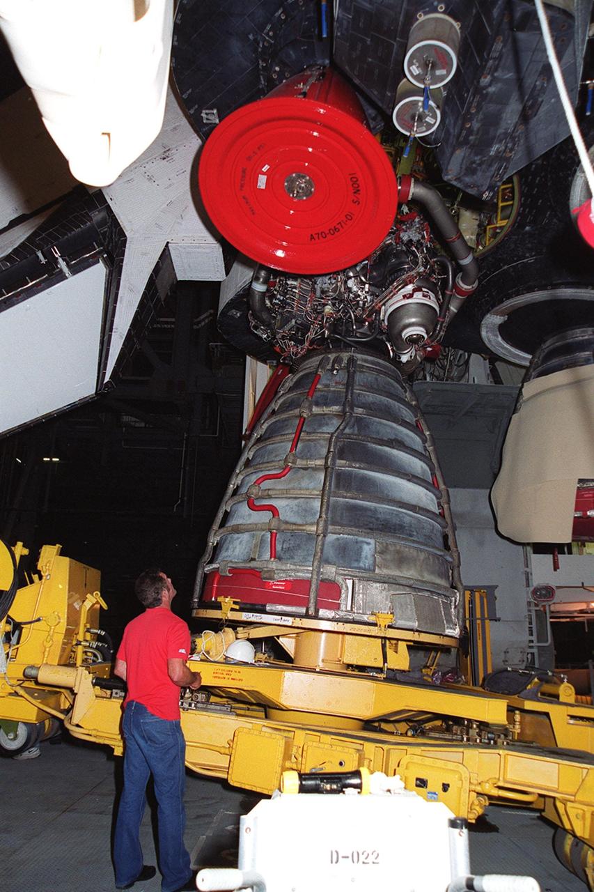 KENNEDY SPACE CENTER, FLA. -- In the Vehicle Assembly Building, Space Shuttle Atlantis' Main Engine No. 1 is lowered onto a transporter. The engine was removed because an inventory review concerning defective main engine fuel pump tip seals indicated that defective seals may be present on the fuel pump for the engine. The decision was made to replace the suspect engine with one originally slated for Discovery. The main engine nozzle, visible in the photo, is 7.8 feet across and 9.4 feet high. Space Shuttle Atlantis is scheduled to launch no earlier than April 17, 2000, on mission STS-101 to resupply the International Space Station for the arrival of the next pressurized module, the Russian-built Zvezda