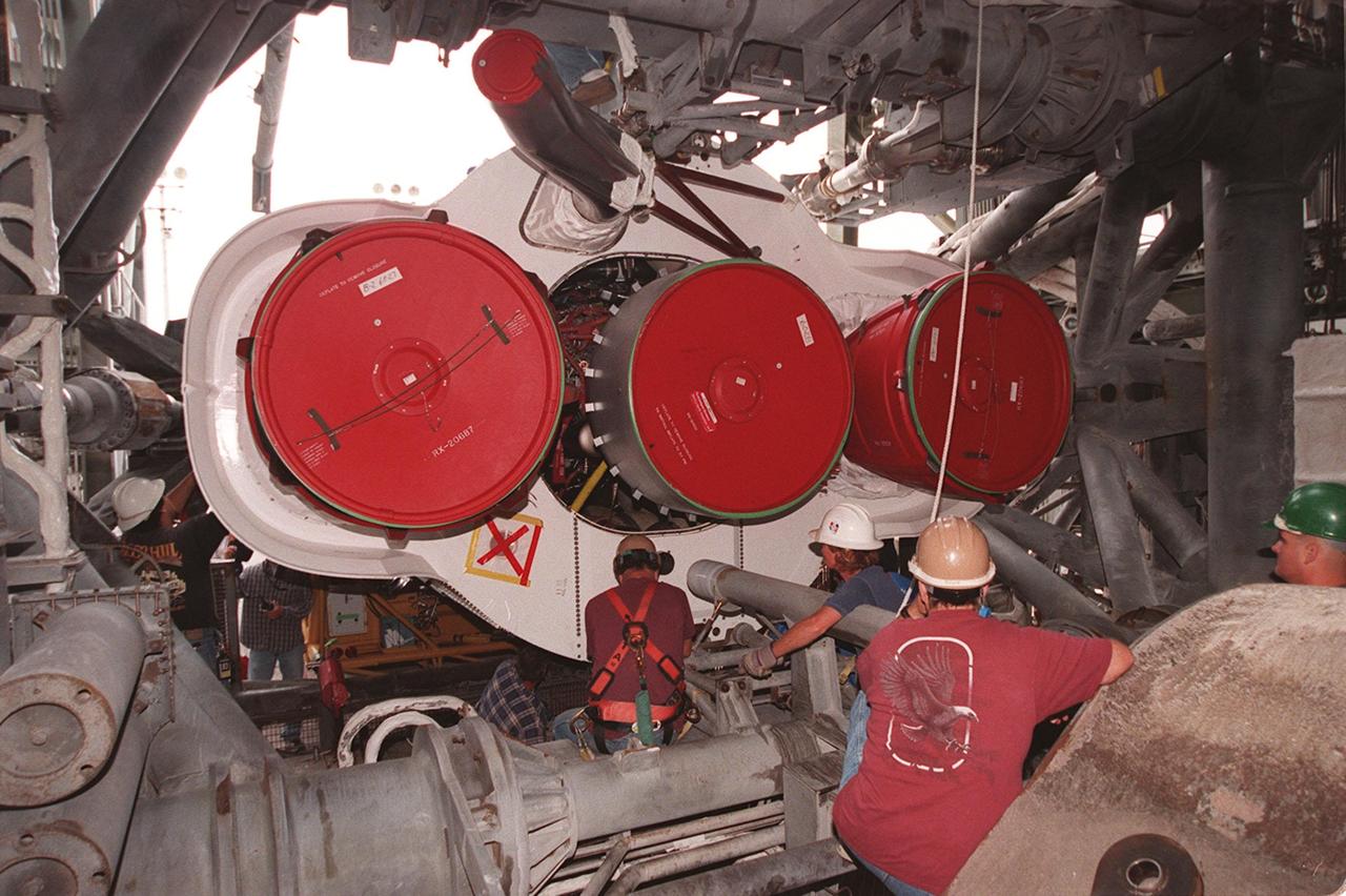 Workers at Cape Canaveral Air Force Station prepare to erect the first stage of an Atlas II/Centaur rocket in the launch gantry on pad 36A. Shown are the rocket thrusters. Atlas II is designed to launch payloads into low earth orbit, geosynchronous transfer orbit or geosynchronous orbit. The rocket is the launch vehicle for the NASA/Lockheed Martin GOES-L satellite, part of the NOAA National Weather Service system in weather imagery and atmospheric sounding information. The primary objective of the GOES-L is to provide a full capability satellite in an on-orbit storage condition, to assure NOAA continuity in services from a two-satellite constellation. Launch services are being provided by the 45th Space Wing