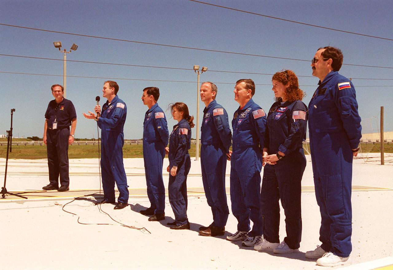 KENNEDY SPACE CENTER, Fla.  --  After Terminal Countdown Demonstration Test (TCDT) activities at Launch Pad 39A, the STS-101 crew talk to the media. At the far left is George Diller, with NASA Public Affairs, who is moderating the event. At the microphone Commander James D. Halsell Jr. answers a question. Next to him, standing left to right, are Pilot Scott J. "Doc" Horowitz and Mission Specialists Mary Ellen Weber, Jeffrey N. Williams, James Voss, Susan J. Helms and Yury Usachev of Russia. The TCDT includes emergency egress training and a simulated launch countdown. During their mission to the International Space Station, the STS-101 crew will be delivering logistics and supplies, plus preparing the Station for the arrival of the Zvezda Service Module, expected to be launched by Russia in July 2000. Also, the crew will conduct one space walk to perform maintenance on the Space Station. This will be the third assembly flight for the Space Station. STS-101 is scheduled to launch April 24 at 4:15 p.m. from Launch Pad 39A