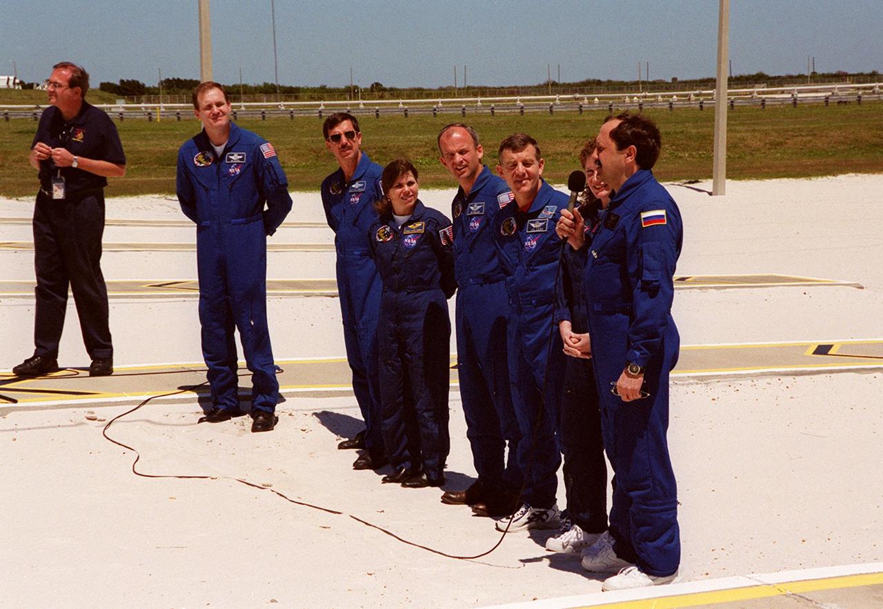 KENNEDY SPACE CENTER, Fla.  -- After Terminal Countdown Demonstration Test (TCDT) activities at Launch Pad 39A, the STS-101 crew answers questions from the media. From left to right are moderator George Diller, with NASA Public Affairs; Commander James D. Halsell Jr. ; Pilot Scott J. "Doc" Horowitz and Mission Specialists Mary Ellen Weber, Jeffrey N. Williams, James S. Voss, Susan J. Helms and Yury Usachev of Russia, with the microphone. The TCDT includes emergency egress training and a simulated launch countdown. During their mission to the International Space Station, the STS-101 crew will be delivering logistics and supplies, plus preparing the Station for the arrival of the Zvezda Service Module, expected to be launched by Russia in July 2000. Also, the crew will conduct one space walk to perform maintenance on the Space Station. This will be the third assembly flight for the Space Station. STS-101 is scheduled to launch April 24 at 4:15 p.m. from Launch Pad 39A