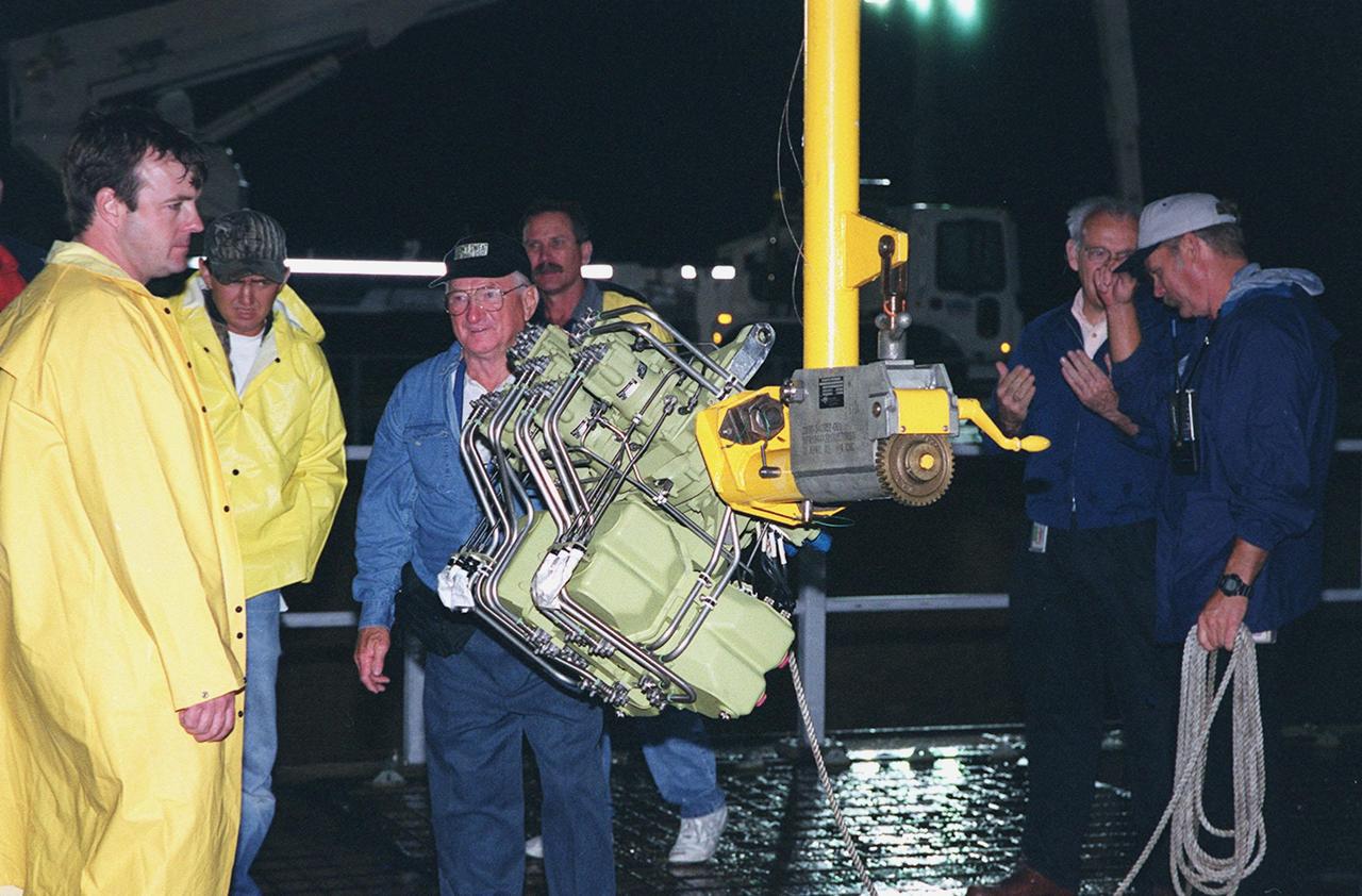 KENNEDY SPACE CENTER, FLA. -- At Launch Pad 39A, workers wait to begin replace Shuttle Atlantis' Power Drive Unit (PDU), which is attached to the crane (center). The PDU controls the rudder/speed brake on the orbiter. Atlantis is scheduled to lift off April 24 at 4:15 p.m. EDT on mission STS-101, the third flight to the International Space Station. The primary mission is to carry logistics and supplies to the Space Station, plus the crew will be preparing the Station for the arrival of the Zvezda Service Module, expected to be launched by Russia in July 2000