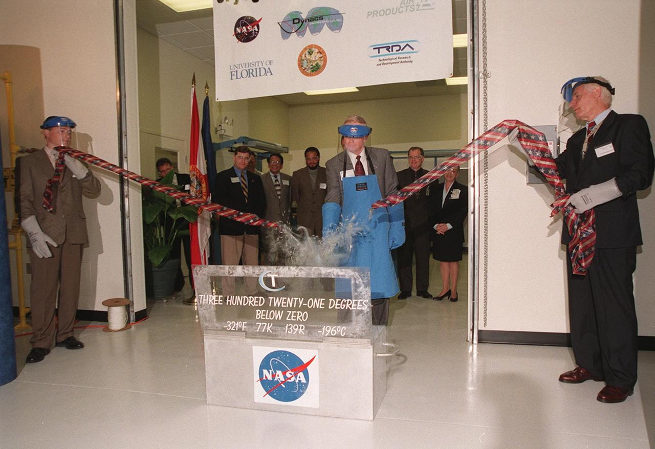 A shower of frozen plastic signifies the successful breaking of the ceremonial &quot;ribbon&quot; at the opening of the new Cryogenic Testbed Facility. Part of the normal ribbon was replaced with plastic tubing and frozen in liquid nitrogen for the event. Bridges hit the tubing with a small hammer to break it. The Cryogenics Testbed was built to provide cryogenics engineering development and testing services to meet the needs of industry. It will also support commercial, government and academic customers for technology development initiatives on the field of cryogenics. The facility is jointly managed by NASA and Dynacs Engineering Co. , NASA/SC's Engineering Development contractor