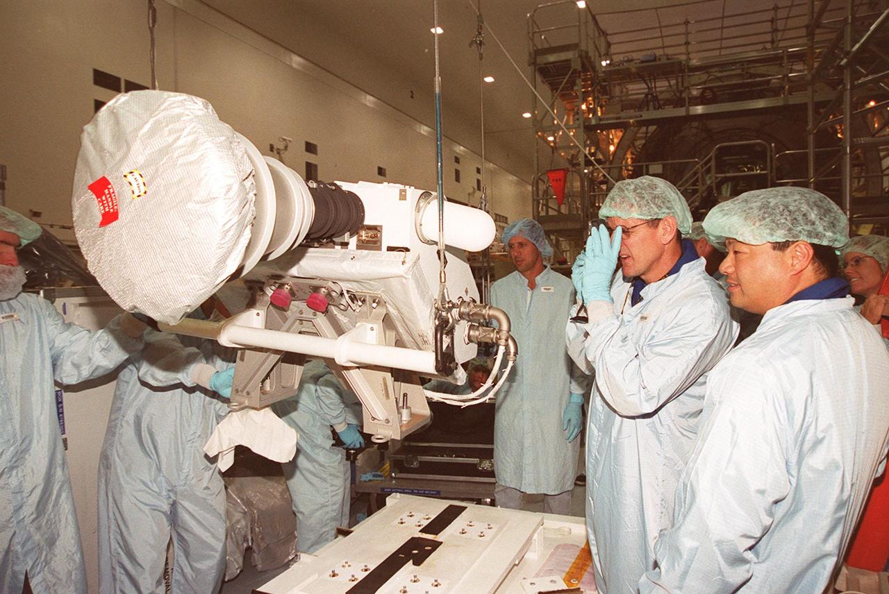 KENNEDY SPACE CENTER, FLA. -- In the Space Station Processing Facility, members of the STS-92 crew examine equipment that will be part of their mission to the International Space Station (ISS). The fourth U.S. flight to the ISS, the mission payload includes the Integrated Truss Structure Z1, an early exterior framework to allow the first U.S. solar arrays on a future flight to be temporarily installed on Unity for early power; Ku-band communication to support early science capability and U.S. television; and PMA-3 to provide a Shuttle docking port for solar array installation on the sixth ISS flight and Lab installation on the seventh ISS flight. The crew comprises Mission Commander Brian Duffy, Pilot Pamela Melroy, and Mission Specialists Koichi Wakata, Leroy Chiao, Peter "Jeff" Wisoff, Michael Lopez-Alegria, and William McArthur. Launch of STS-92 is scheduled for Sept. 21, 2000. Wakata is with the National Space Development Agency of Japan.