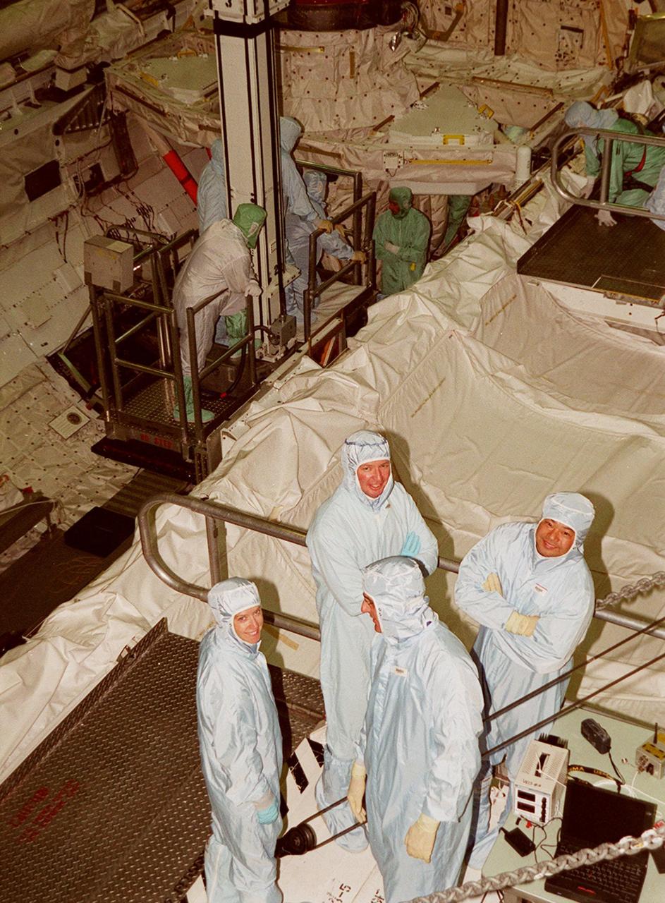 KENNEDY SPACE CENTER, FLA. -- Members of the STS-92 crew pose for the photographer during a break from checking out Discovery's payload bay in the Orbiter Processing Facility bay 1. Their mission, the fourth U.S. flight to the ISS, includes as payload the Integrated Truss Structure Z1, an early exterior framework to allow the first U.S. solar arrays on a future flight to be temporarily installed on Unity for early power; Ku-band communication to support early science capability and U.S. television; and PMA-3 to provide a Shuttle docking port for solar array installation on the sixth ISS flight and Lab installation on the seventh ISS flight. The crew comprises Mission Commander Brian Duffy, Pilot Pamela Melroy, and Mission Specialists Koichi Wakata, Leroy Chiao, Peter "Jeff" Wisoff, Michael Lopez-Alegria, and William McArthur. Launch of STS-92 is scheduled for Sept. 21, 2000. Wakata is with the National Space Development Agency of Japan