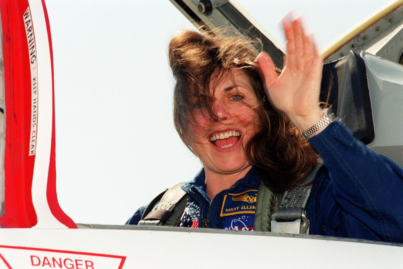 STS-101 Mission Specialist Mary Ellen Weber is confronted by a strong wind on her arrival at KSC's Shuttle Landing Facility. She and the rest of the crew are at KSC to get ready for their launch on April 24 about 4:15 p.m. EDT from Launch Pad 39A. During their mission to the International Space Station, the STS-101 crew will be delivering logistics and supplies, plus preparing the Station for the arrival of the Zvezda Service Module, expected to be launched by Russia in July 2000. Also, the crew will conduct one space walk to perform maintenance on the Space Station. This will be the third assembly flight for the Space Station