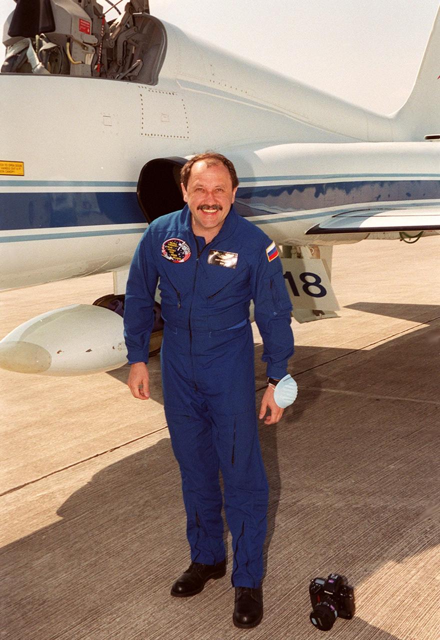 STS-101 Yury Usachev of Russia smiles on his arrival at KSC's Shuttle Landing Facility aboard the T-38 jet aircraft behind him. He and the rest of the crew are at KSC to get ready for their launch on April 24 about 4:15 p.m. EDT from Launch Pad 39A. The mission will take the crew to the International Space Station, delivering logistics and supplies, plus preparing the Station for the arrival of the Zvezda Service Module, expected to be launched by Russia in July 2000. Also, the crew will conduct one space walk to perform maintenance on the Space Station. This will be the third assembly flight for the Space Station