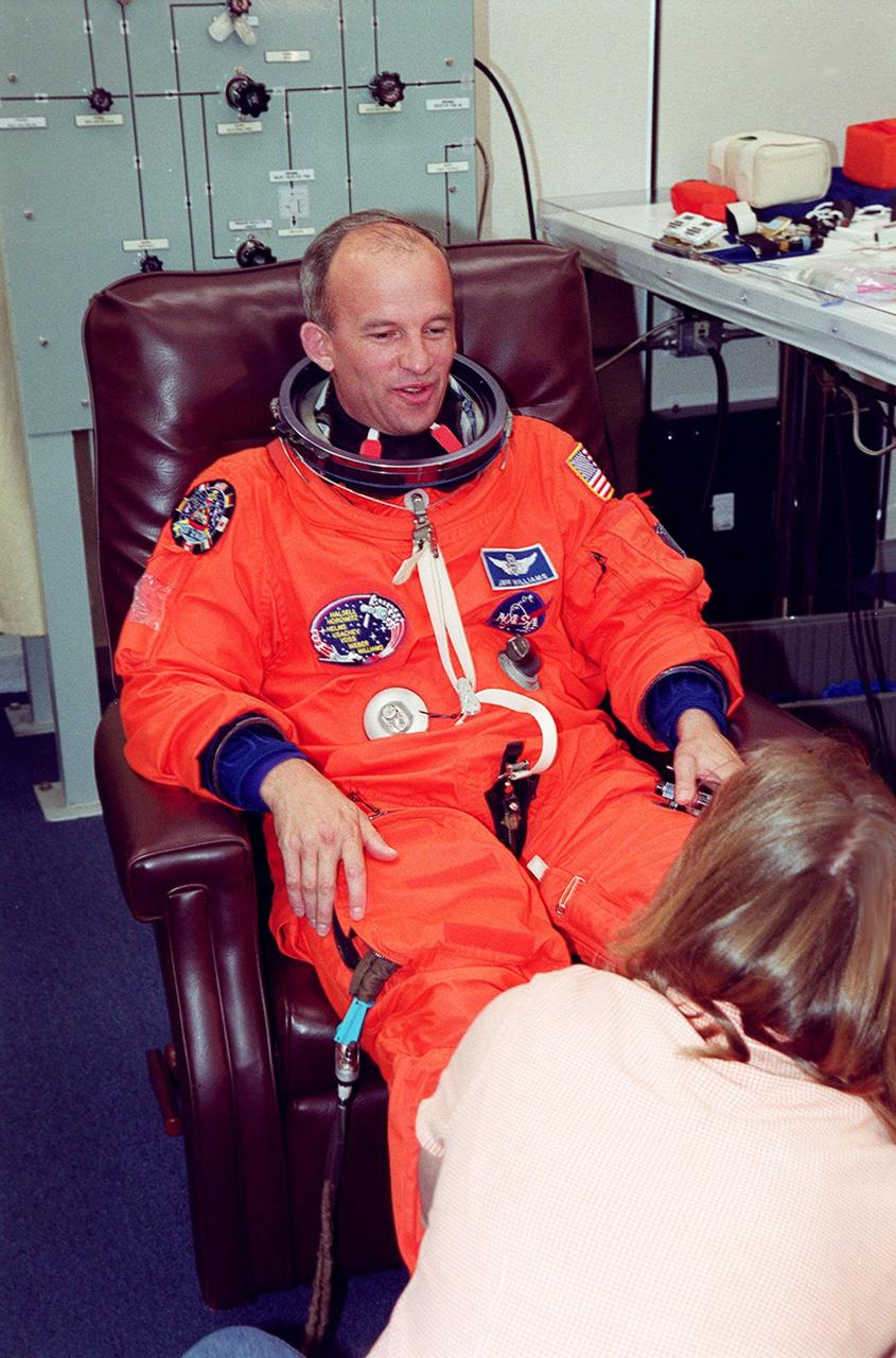 STS-101 Mission Specialist Jeffrey Williams has his launch and entry suit checked during pre-launch preparations in the Operations and Checkout Building. Mission STS-101 will take the crew to the International Space Station to deliver logistics and supplies, plus prepare the Station for the arrival of the Zvezda Service Module, expected to be launched by Russia in July 2000. The crew will conduct one space walk to perform maintenance on the Space Station as well. This will be the third assembly flight for the Space Station. Launch is targeted for April 24 at about 4:15 p.m. EDT from Launch Pad 39A