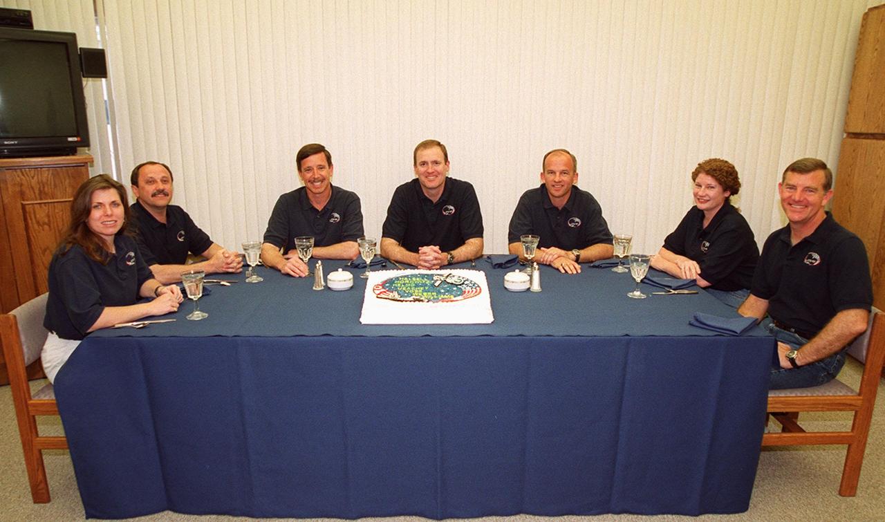 In the Operations and Checkout Building, the STS-101 crew gathers for a snack before suiting up for launch. From left are Mission Specialists Mary Ellen Weber and Yury Usachev of Russia; Pilot Scott J. Horowitz; Commander James D. Halsell Jr.; and Mission Specialists Jeffrey N. Williams, Susan J. Helms and James S. Voss. The mission will take the crew to the International Space Station to deliver logistics and supplies and prepare the Station for the arrival of the Zvezda Service Module, expected to be launched by Russia in July 2000. Also, the crew will conduct one space walk. This will be the third assembly flight to the Space Station