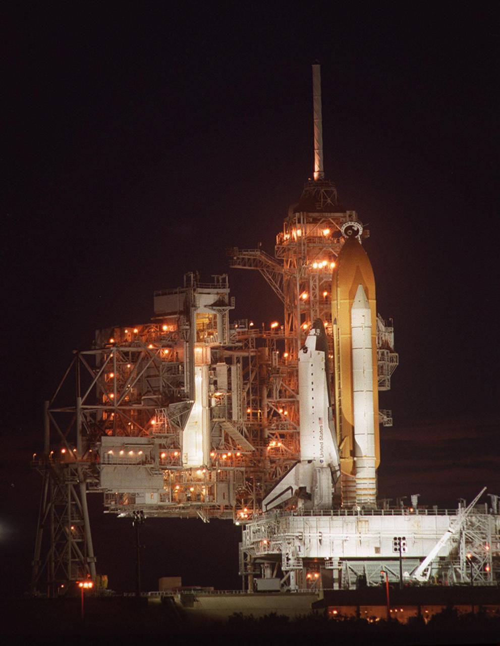 KENNEDY SPACE CENTER, Fla.  -- The Rotating Service Structure (left) begins rolling back from Space Shuttle Atlantis on Launch Pad 39A. Atlantis is targeted for liftoff at 4:15 p.m. EDT April 24 on mission STS-101. The mission will take the crew of seven to the International Space Station to deliver logistics and supplies and prepare the Station for the arrival of the Zvezda Service Module, expected to be launched by Russia in July 2000. Also, the crew will conduct one space walk. This will be the third assembly flight to the Space Station