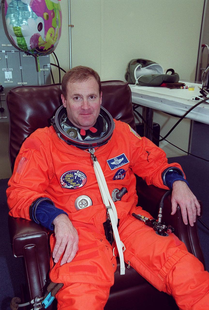 In the Operations and Checkout Building, STS-101 Commander James D. Halsell Jr. appears relaxed while waiting to finish suiting up before heading to Launch Pad 39A and launch of Space Shuttle Atlantis. The mission will take the crew to the International Space Station to deliver logistics and supplies and to prepare the Station for the arrival of the Zvezda Service Module, expected to be launched by Russia in July 2000. Also, the crew will conduct one space walk. This will be the third assembly flight to the Space Station